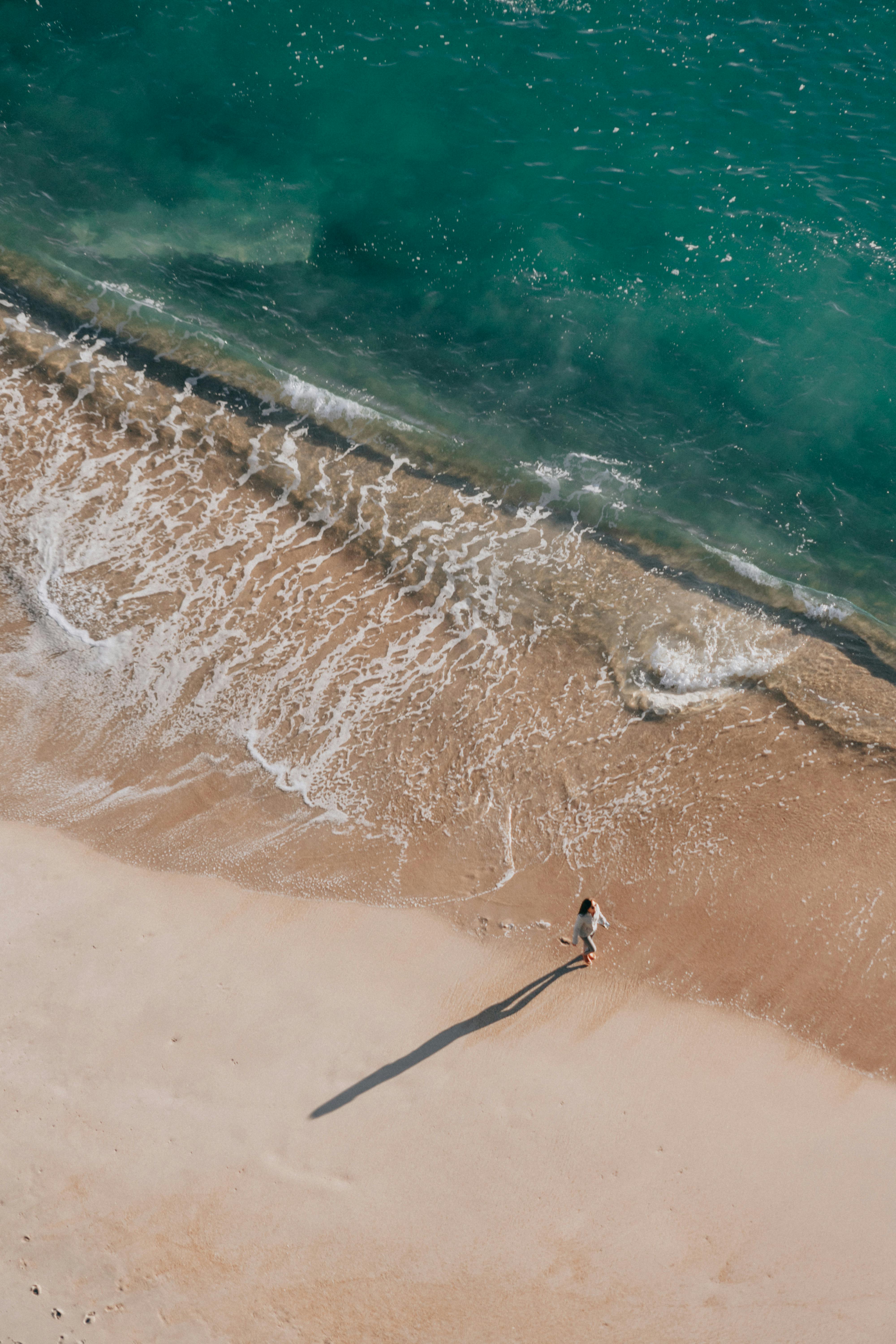 A woman walking on a beach | Source: Pexels