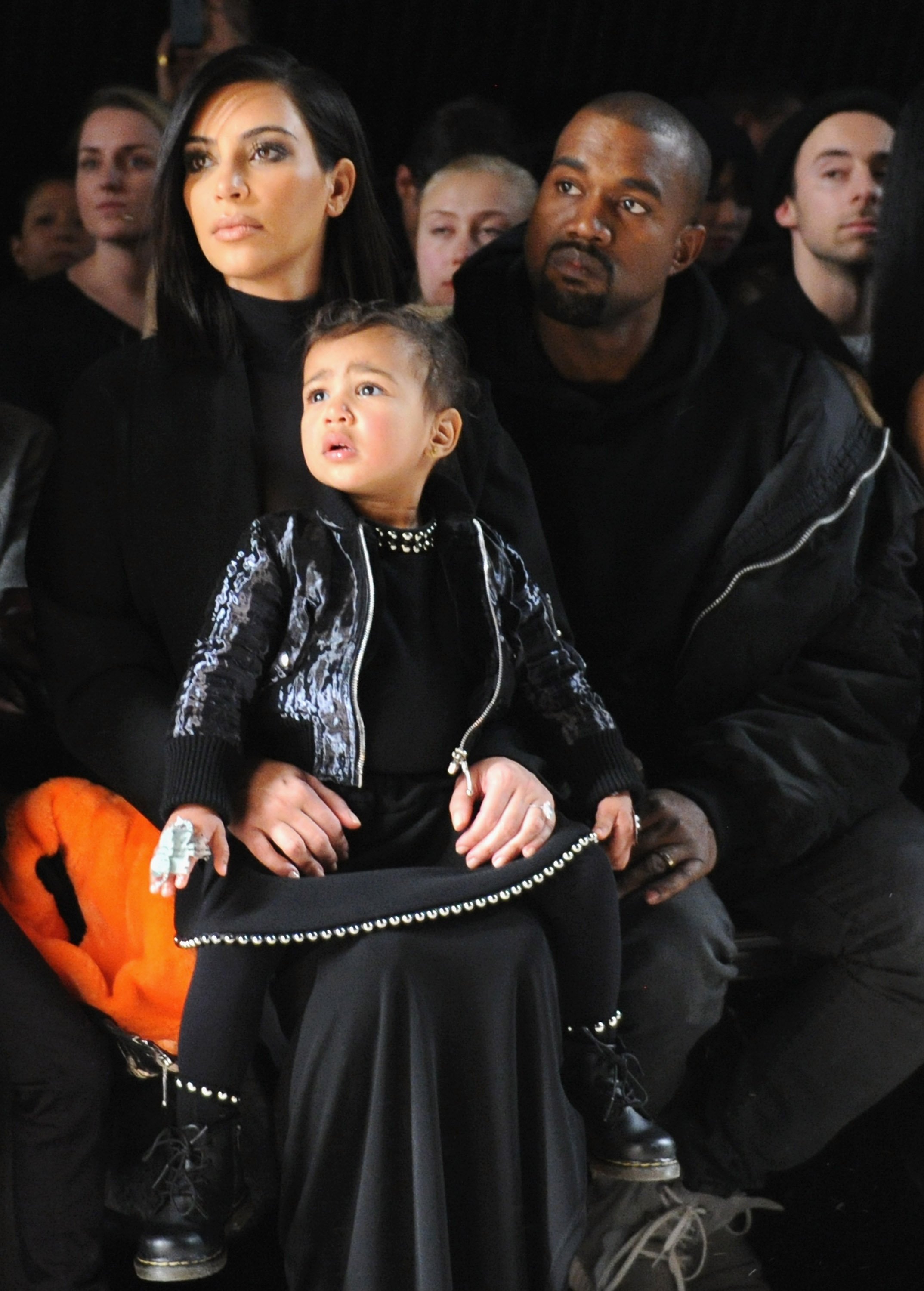 Kim Kardashian, North West and Kanye West attend the Alexander Wang Fashion Show during Mercedes-Benz Fashion Week Fall 2015 at Pier 94 on February 14, 2015, in New York City. | Source: Getty Images.
