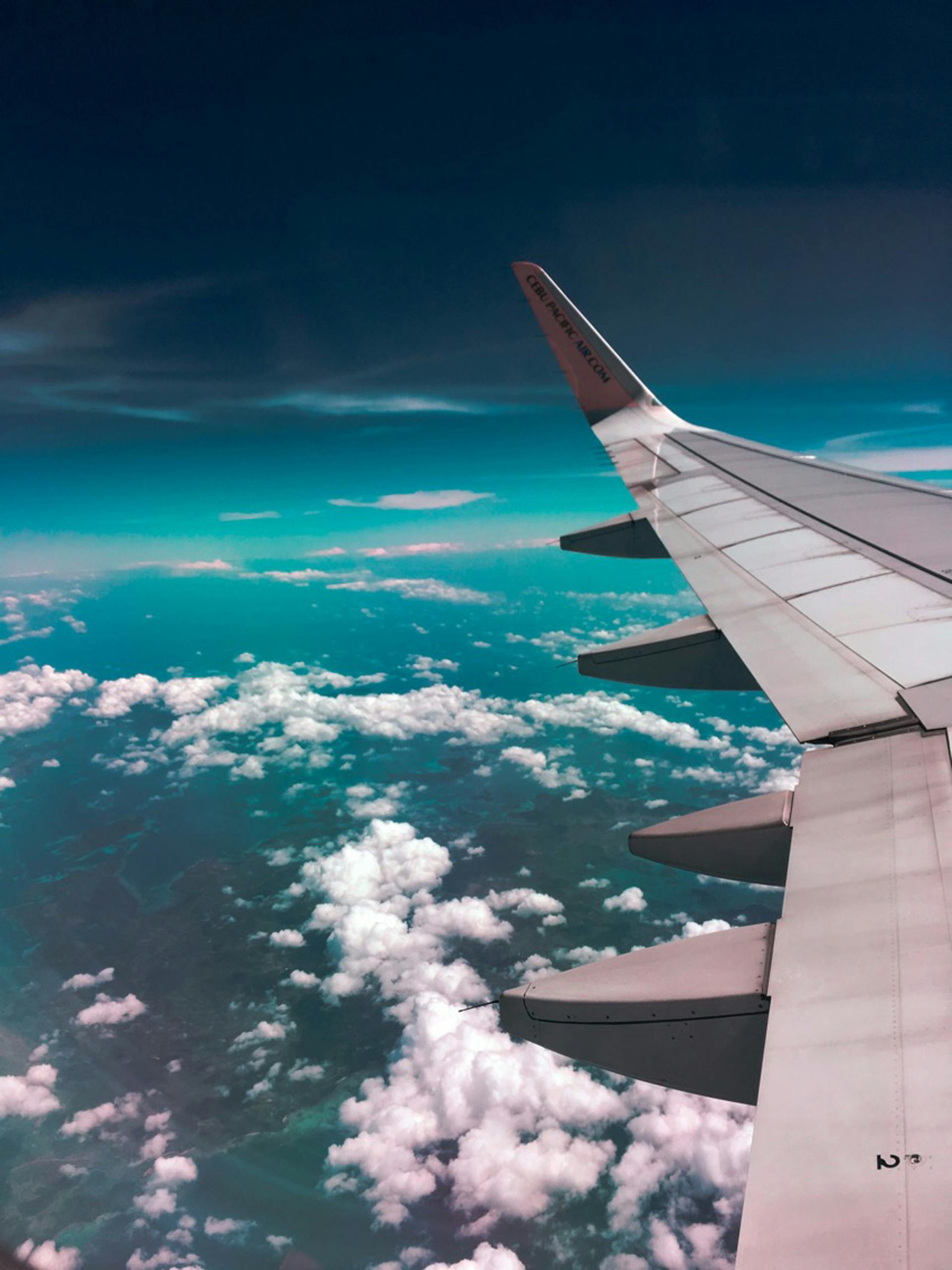 An airplane wing above clouds | Source: Pexels