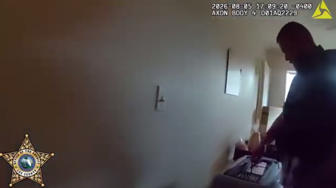 Bodycam footage showing officer holding the cat carrier as he takes Luna, the kitten, away from the home in Fort Myers, posted on August 6, 2026. | Source: Facebook/Lee County Sheriff's Office