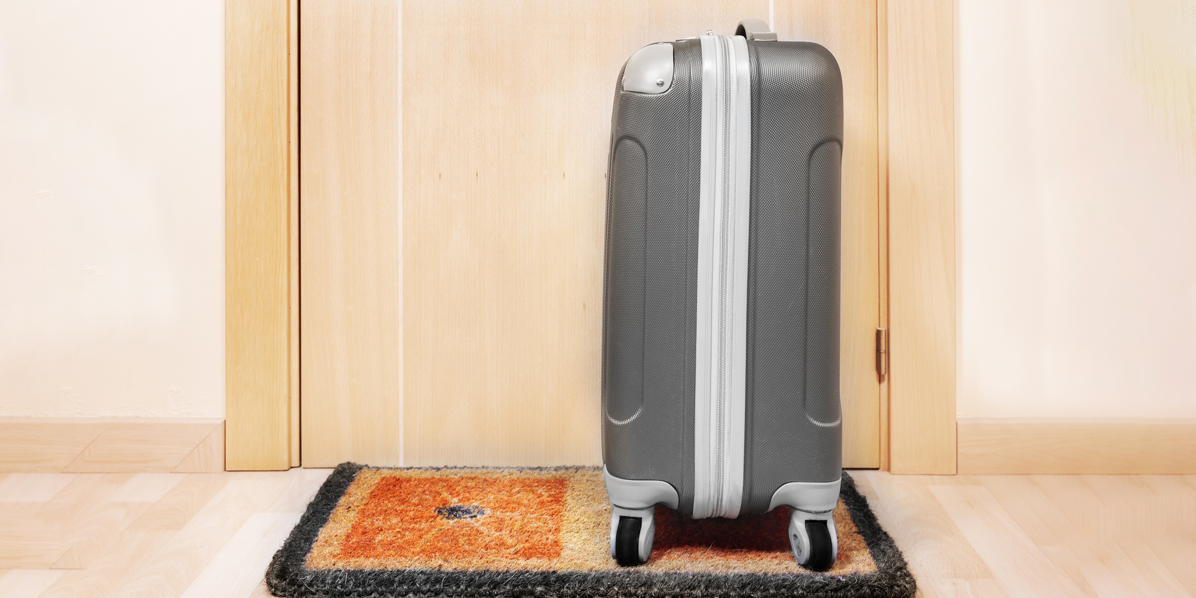 A suitcase lying on a doorstep | Source: Shutterstock