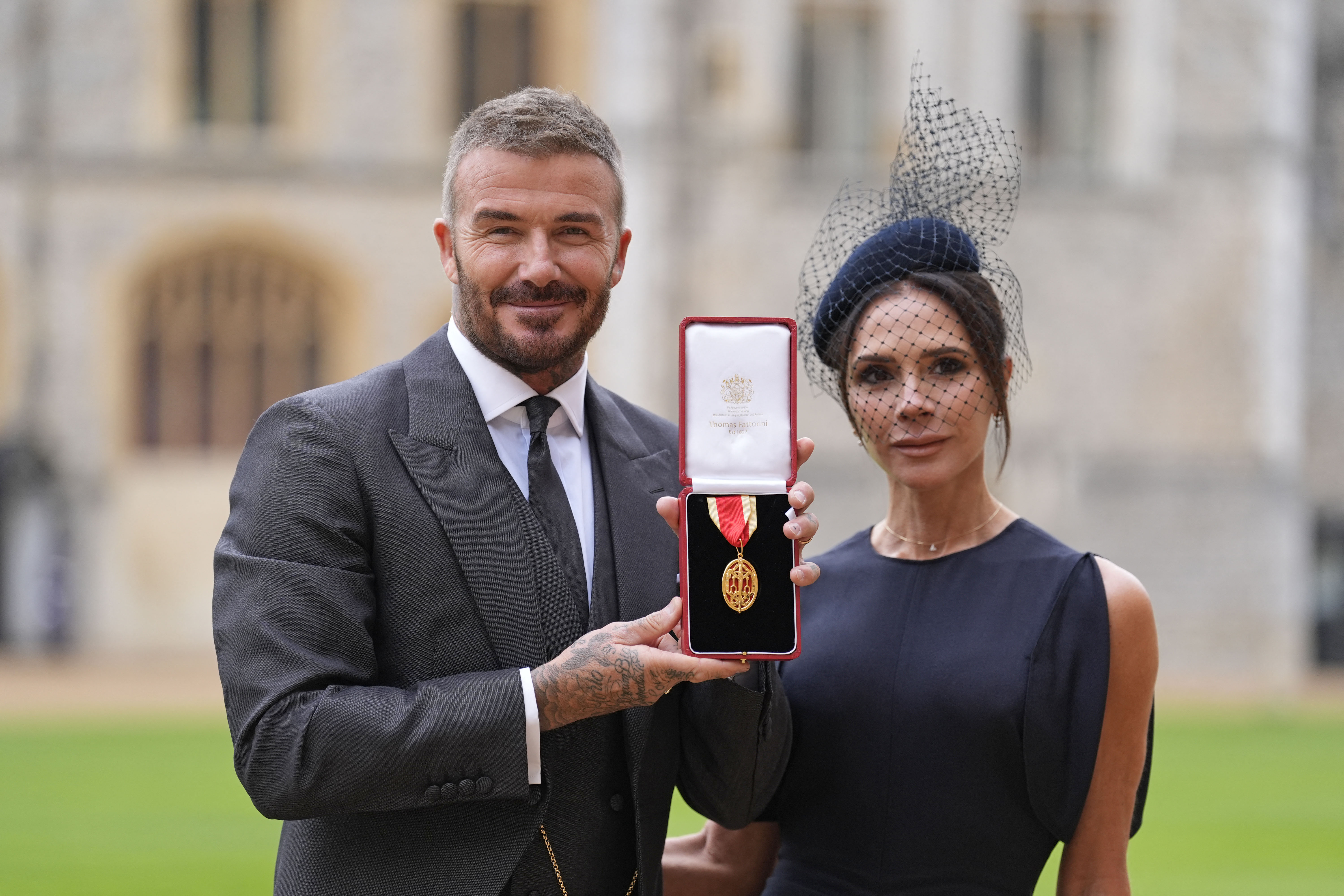 David Beckham poses with his wife, Victoria, and his medal after receiving a knighthood at Windsor Castle, on November 4, 2025 | Source: Getty Images