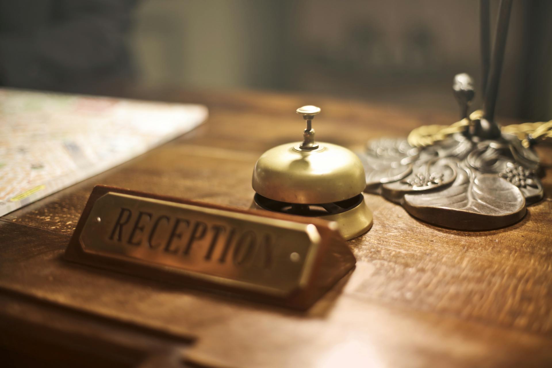 A reception desk with an antique hotel bell | Source: Pexels