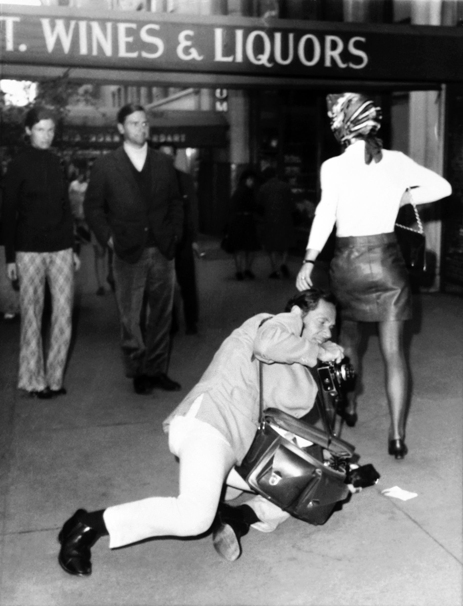 In this striking shot by photographer Nick Machalaba, Jackie Onassis flips the script — quite literally — on a persistent paparazzo. Captured mid-stride in a leather skirt and headscarf, she turns just as the photographer dives to capture his shot.