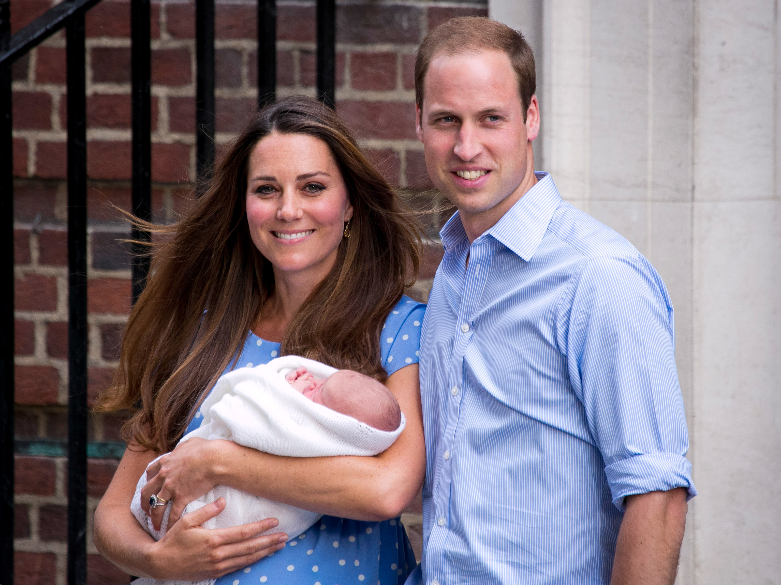 Beaming with pride, Kate Middleton cradles her newborn son alongside Prince William as the couple introduces the tiny future king to the world, creating an instant royal classic.