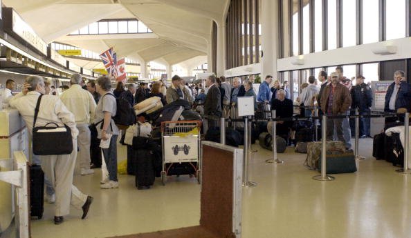 Passengers wait at the American Airlines check-in counter. | Source: Getty Images.