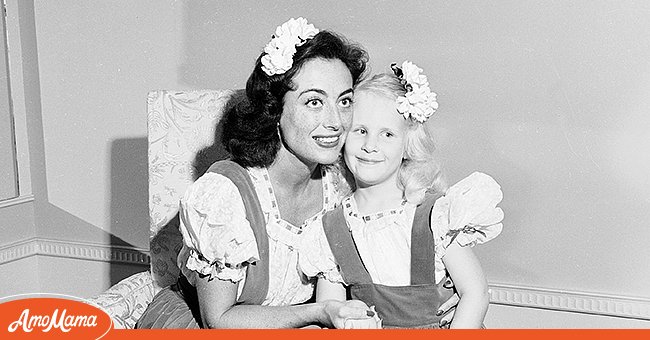 American actress Joan Crawford posing with her adopted daughter Christina, donning matching outfits in June 1944. / Source: Getty Images