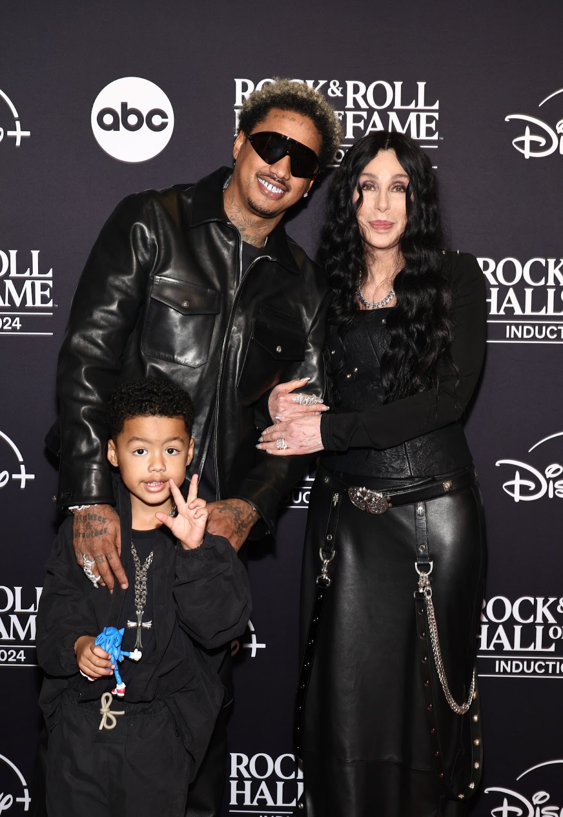 Slash Electric Alexander and Alexander "AE" Edwards with Cher at the 2024 Rock & Roll Hall of Fame Induction Ceremony on October 19 in Cleveland, Ohio. | Source: Getty Images