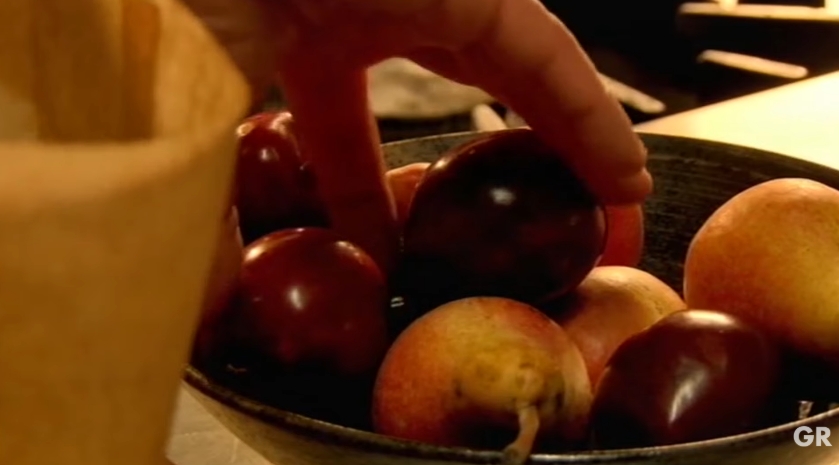 Gordon Ramsay reaches for a piece of fruit while demonstrating one of his simplest kitchen tricks. He explains that placing unripe fruit in a paper bag with a banana and storing it in a dark place can naturally speed up the ripening process, helping it become ready to eat much sooner. | Source: YouTube/ Gordon Ramsay