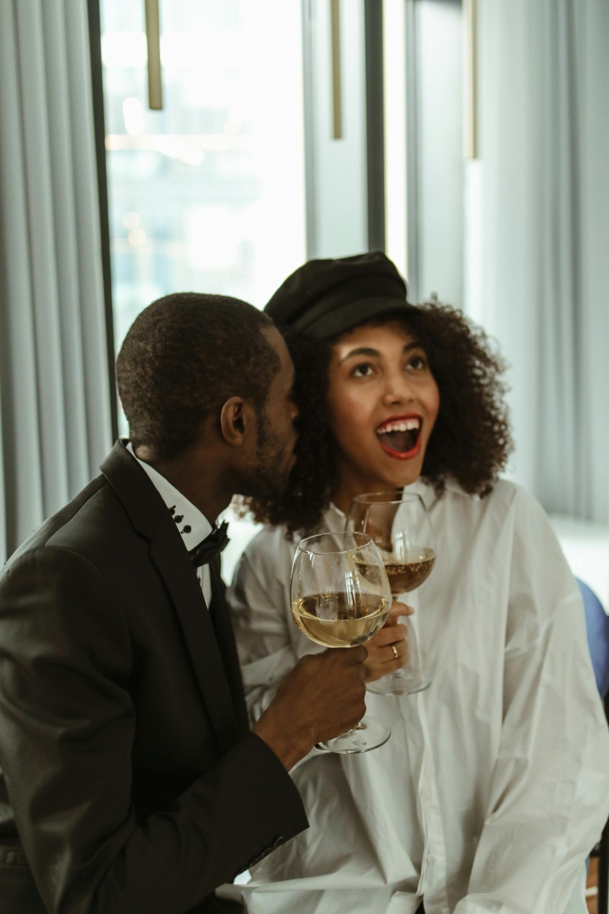 A woman reacting in shock while the man besides her stays calm | Source: Pexels