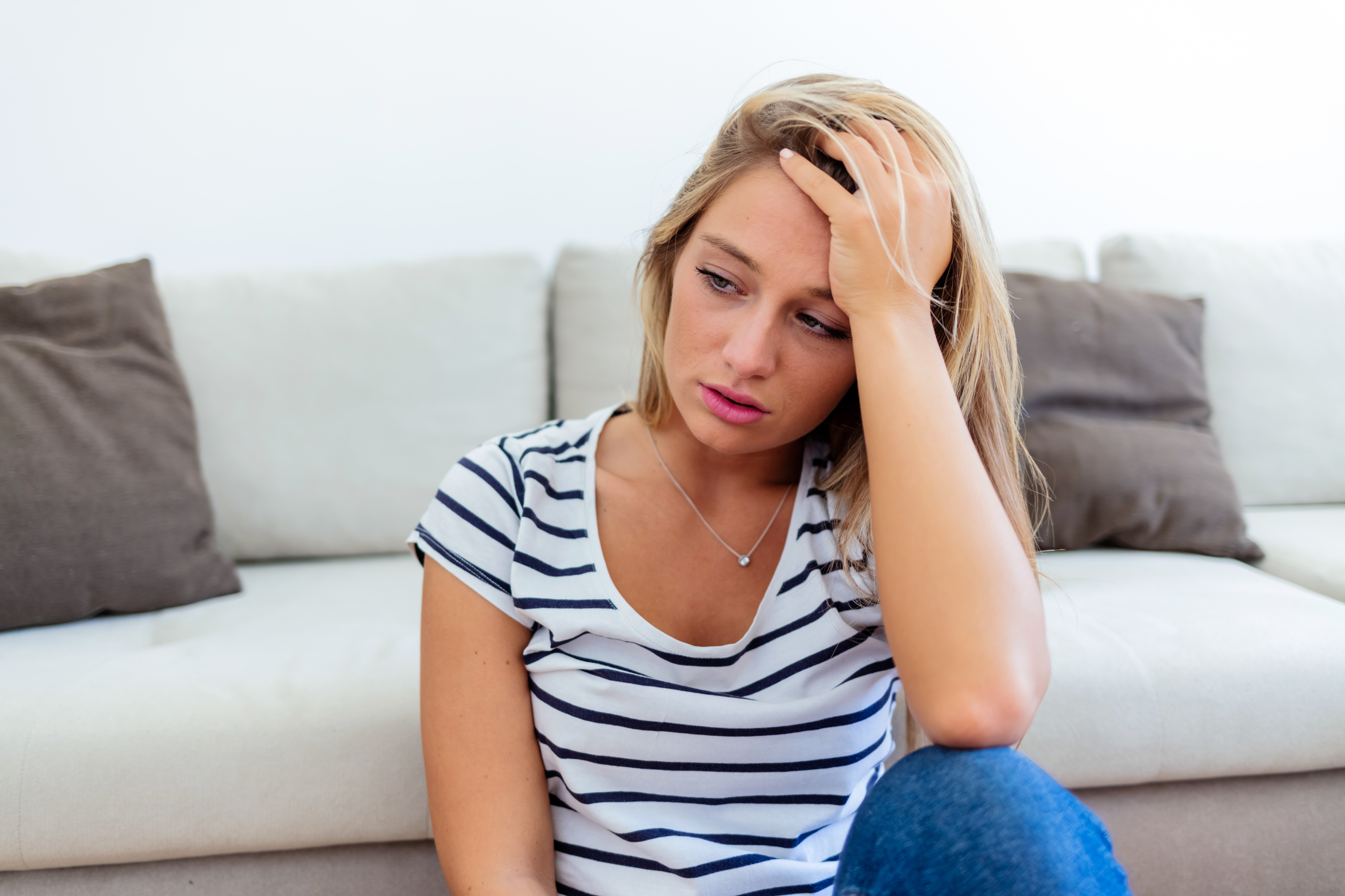 Depressed upset young woman feeling hurt sad stressed troubled with unwanted pregnancy, regret mistake abortion, having headache or drug addiction, suffer from grief dramatic bad problem concept | Source: Getty Images