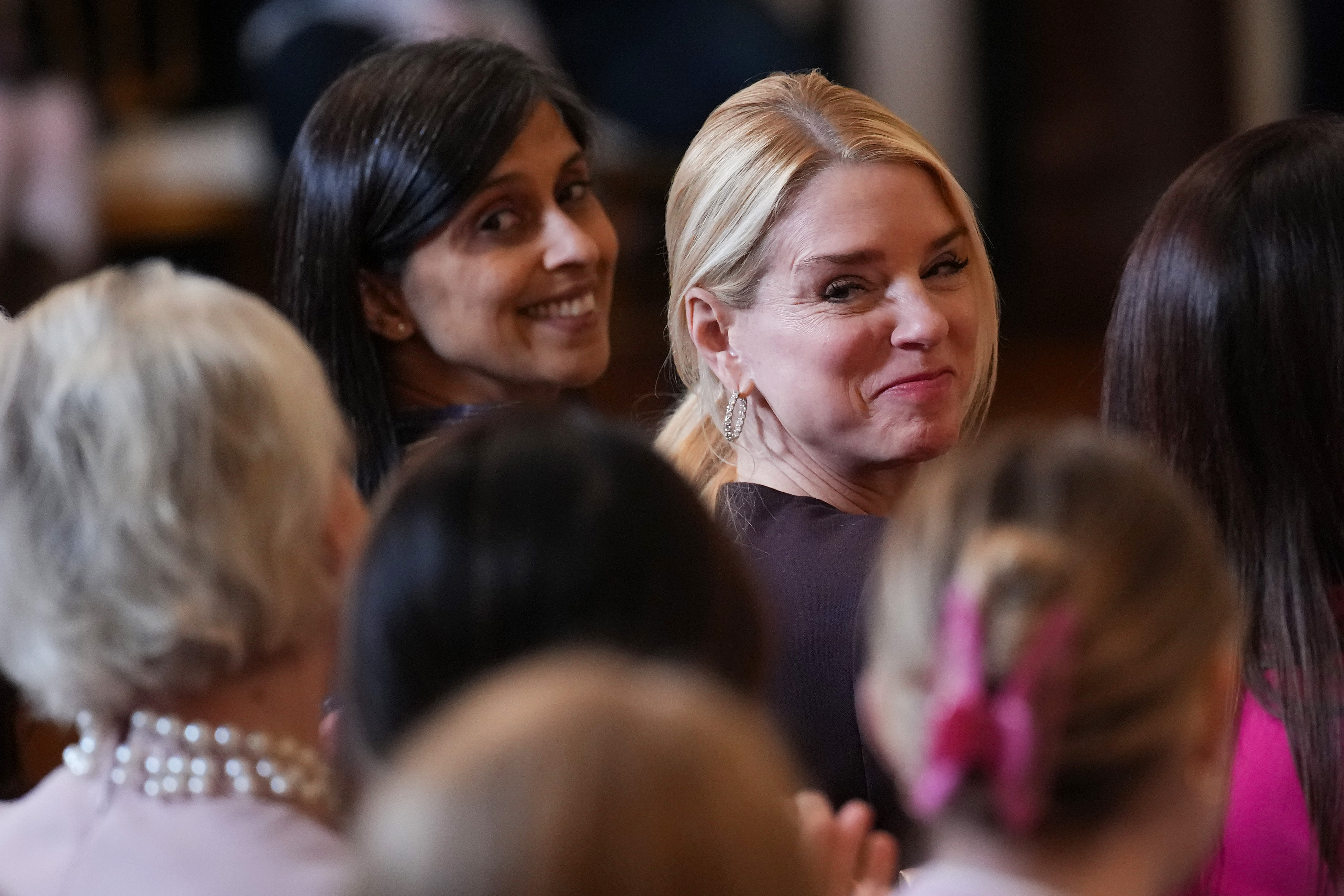 Usha Vance and Pam Bondi attend a Women's History Month event in the East Room of the White House in Washington, DC on March 12, 2026. | Source: Getty Images