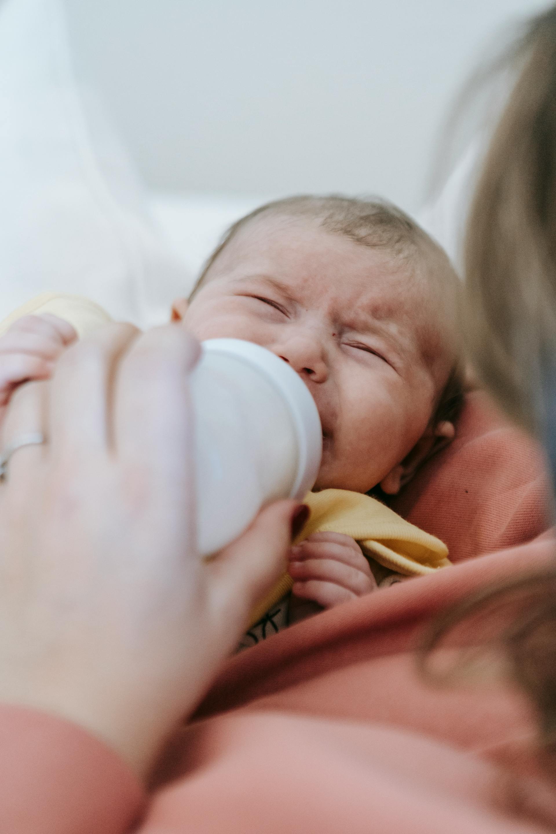 A woman feeding a crying baby | Source: Pexels