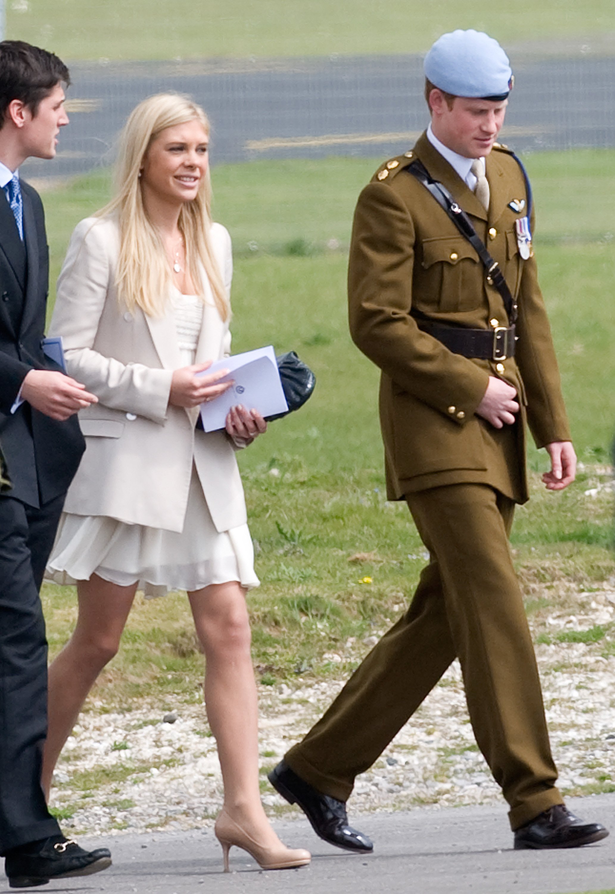 Chelsy and Davy and Prince Harry walking after he received his flying badges at the Museum of Army Flying. | Source: Getty Images
