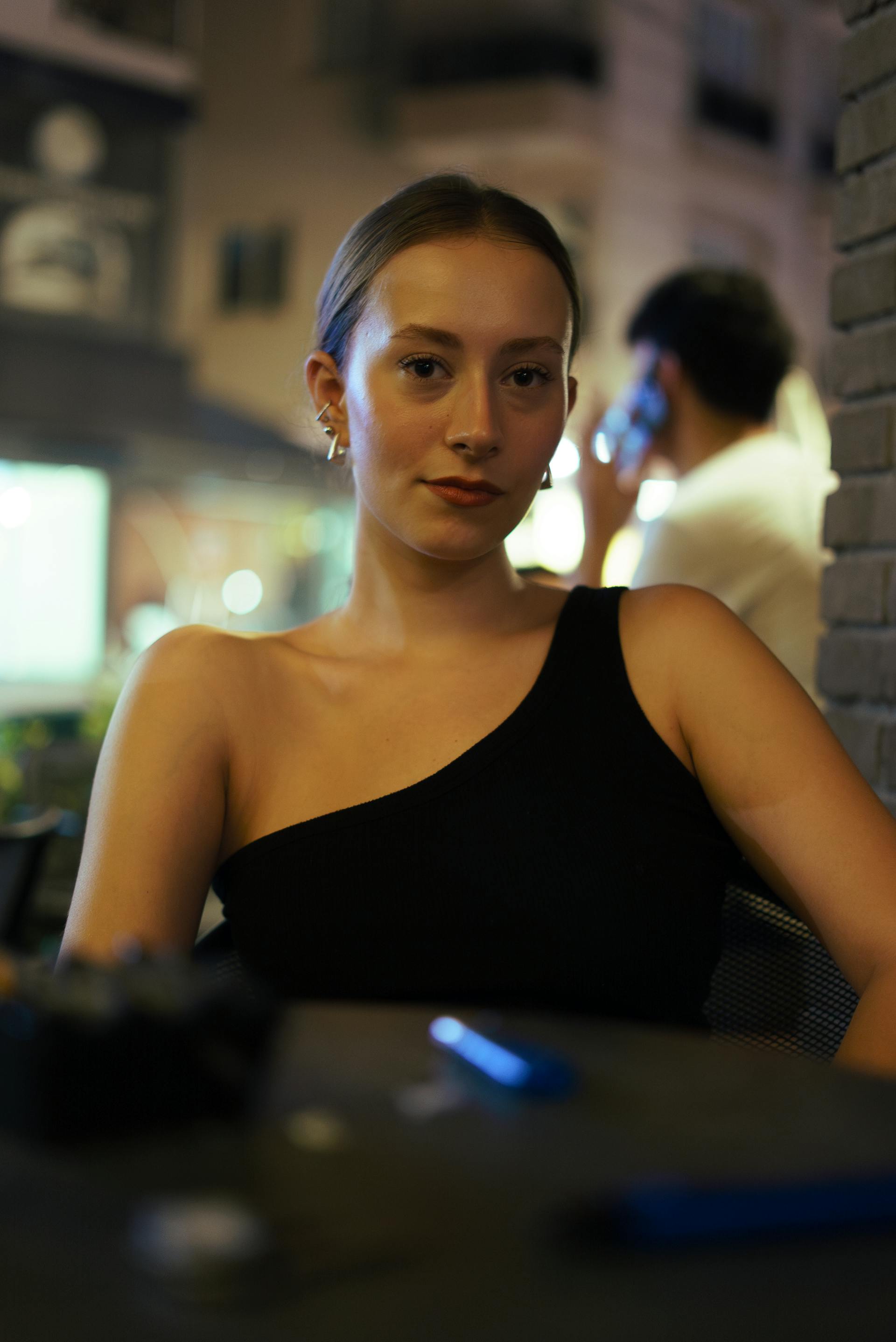A woman sitting in a black dress | Source: Pexels