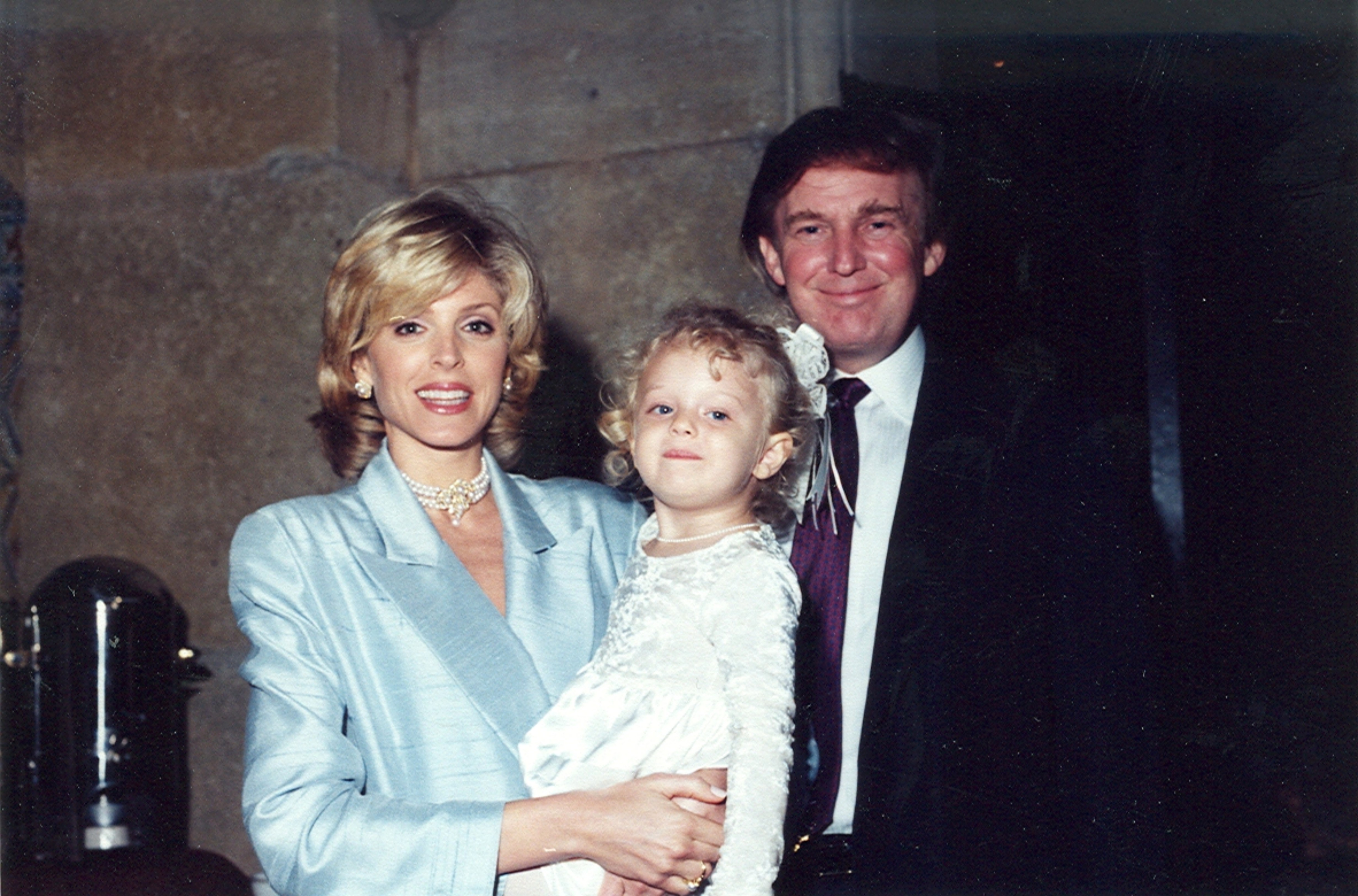Marla Maples and Donald Trump with their daughter Tiffany, as they pose together at the Mar-a-Lago estate in Palm Beach, Florida in 1996 | Source: Getty Images