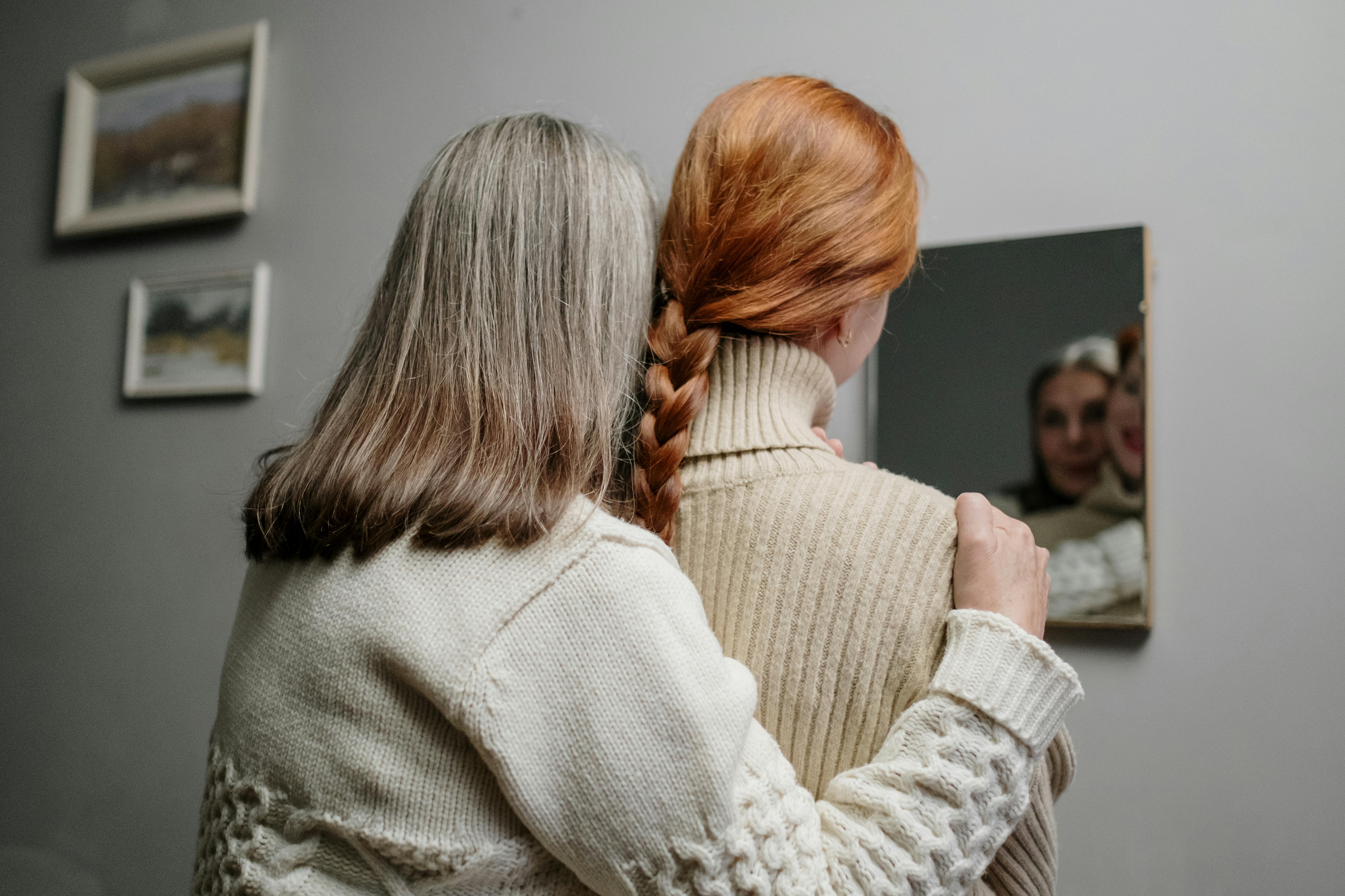 A young woman and senior woman looking into the mirror | Source: Pexels