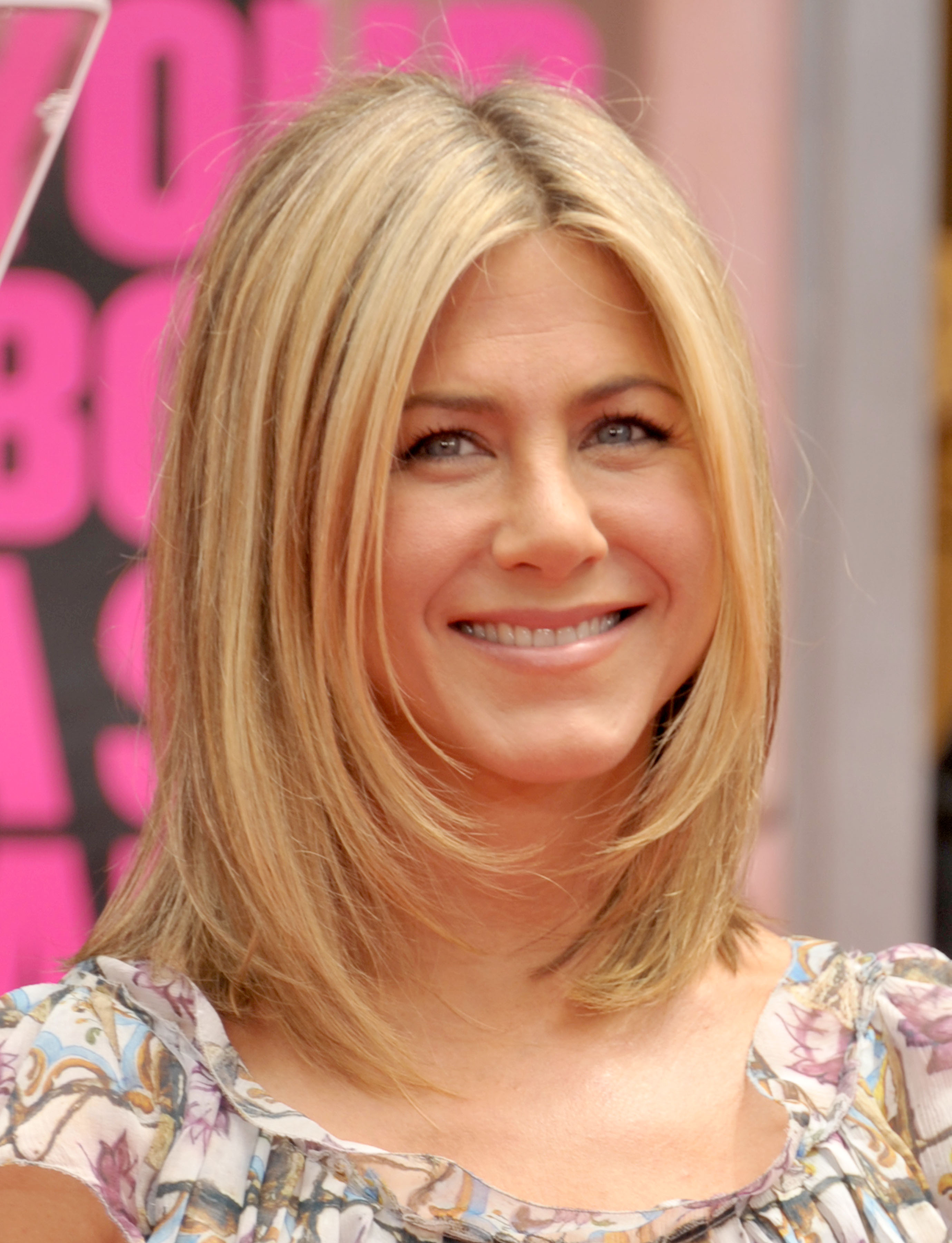 Aniston attends her hand and footprint ceremony at Grauman's Chinese Theatre in Hollywood in July 2011. The actress has often spoken about aging and beauty standards during her career. | Source: Getty Images