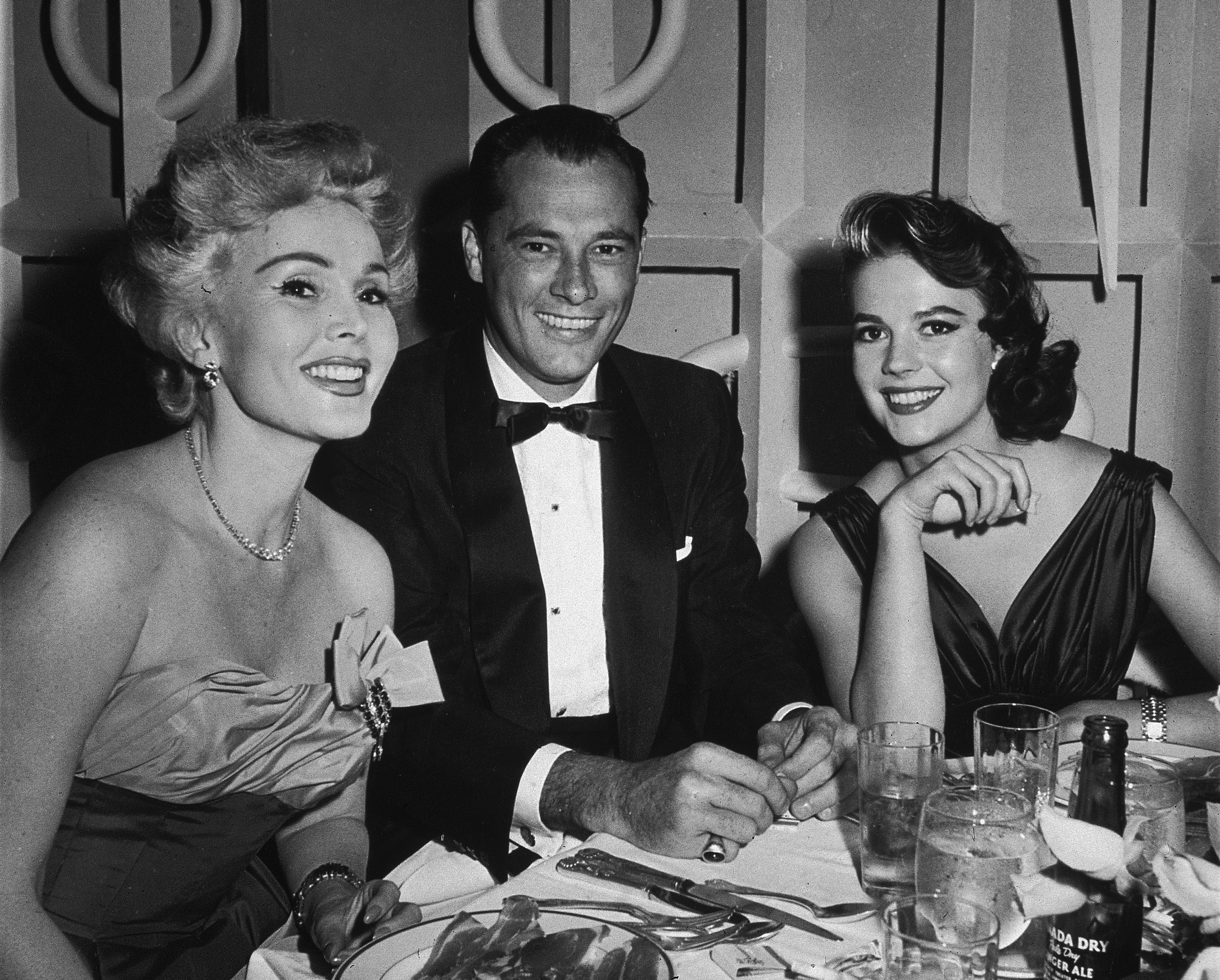 Zsa Zsa Gabor with her husband Conrad 'Nicky' Hilton, and actor Natalie Wood at Mike Romanoff's Restaurant on June, 13, 1957. | Source: Getty Images