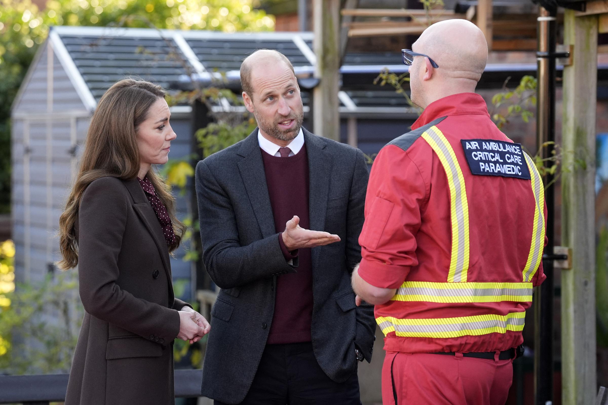 Prince William and Catherine, Princess of Wales speak to a member of the emergency services during a visit to Southport, north west England on October 10, 2024 | Source: Getty Images