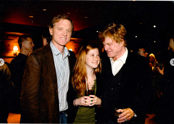 Lena Redford sharing a moment with her dad, James Redford, and her grandfather, Robert Redford, at an event. | Source: Instagram/lilredford