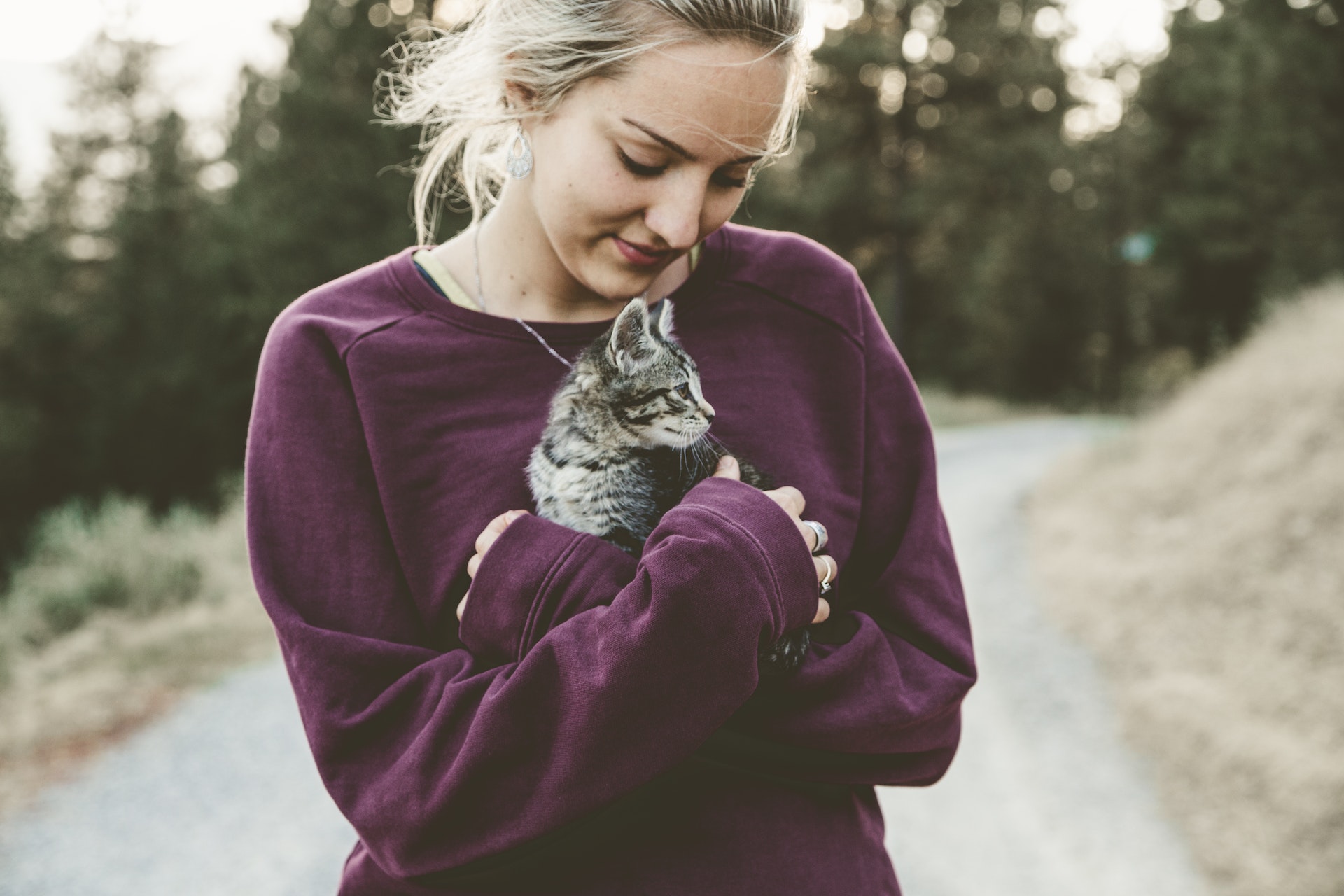 A young woman holding a cat | Source: Shutterstock