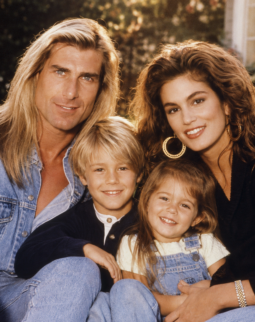 An AI-imagined family portrait shows Fabio and Cindy Crawford smiling alongside their young son and daughter, all wearing casual denim and dark tops reminiscent of mid-1990s magazine spreads. | Source: ChatGPT
