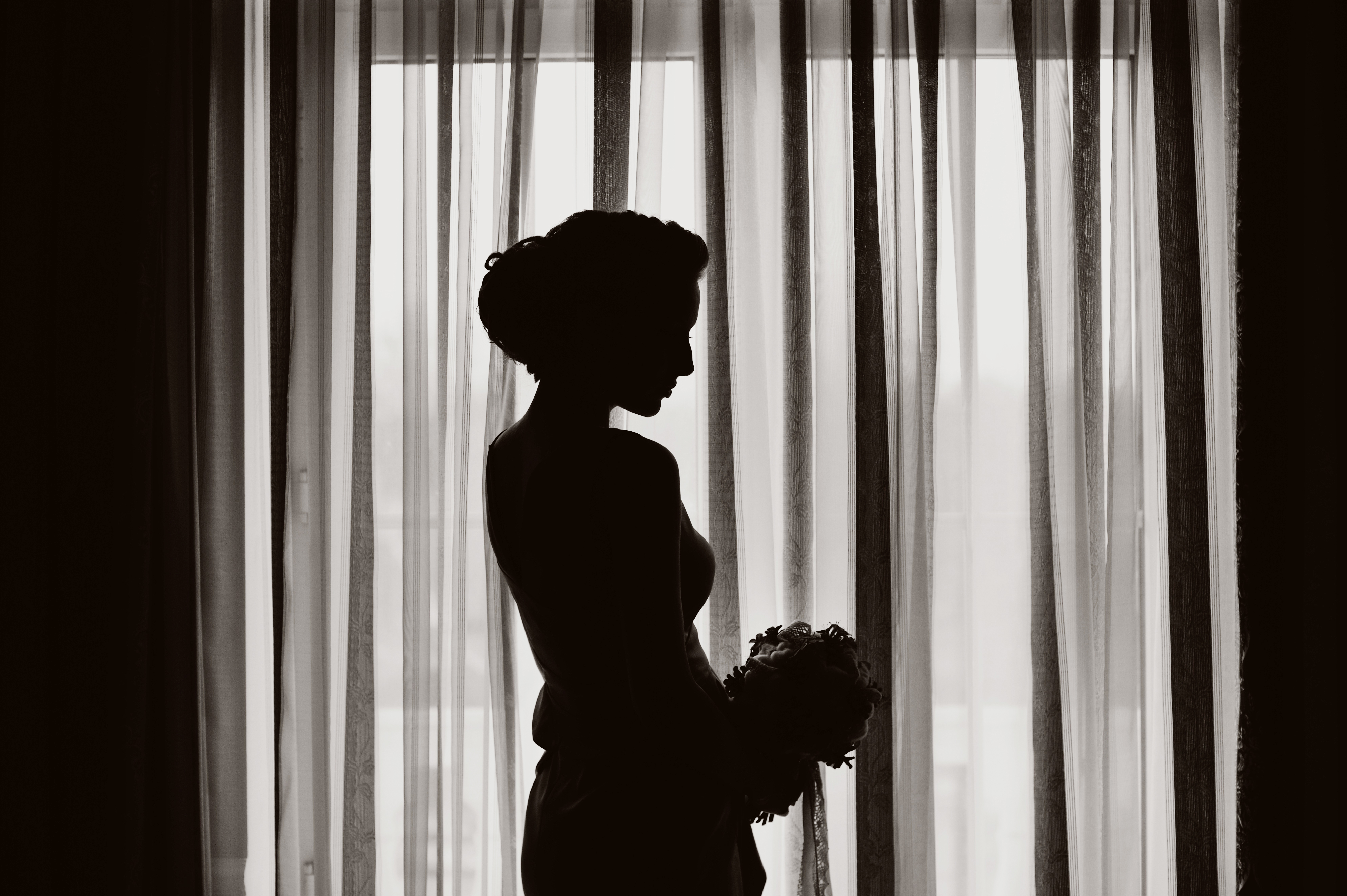 Silhouette of a woman standing near a window | Source: Shutterstock