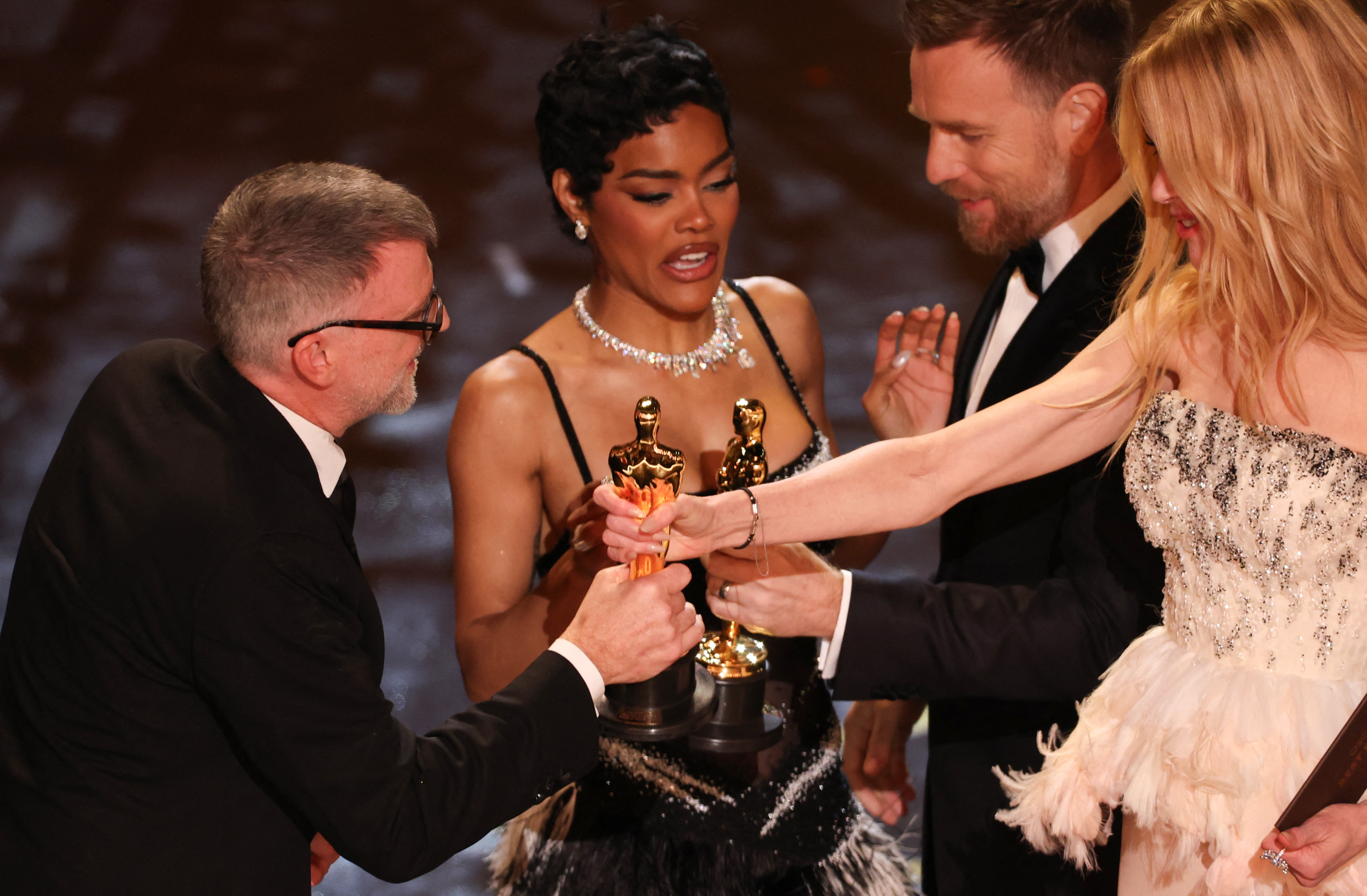 Paul Thomas Anderson and Teyana Taylor accept the award for Best Picture for "One Battle After Another" from Ewan Mcgregor and Nicole Kidman | Source: Getty Images