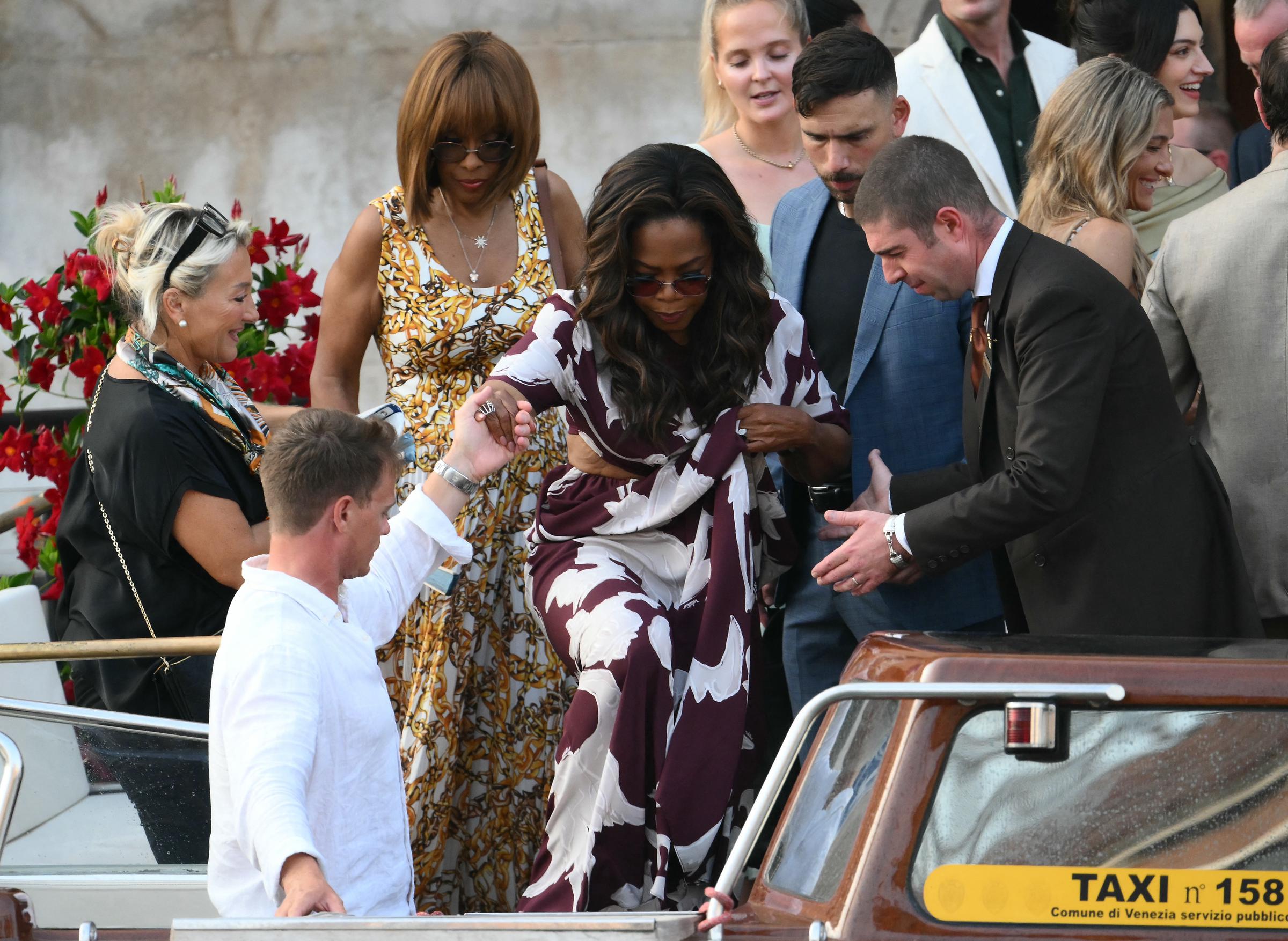 US talk show host Oprah Winfrey and US journalist Gayle King get on a taxi boat as they leave the Gritti Palace Hotel ahead of the wedding of Amazon's founder Jeff Bezos with Lauren Sanchez in Venice, Italy on June 26, 2026.