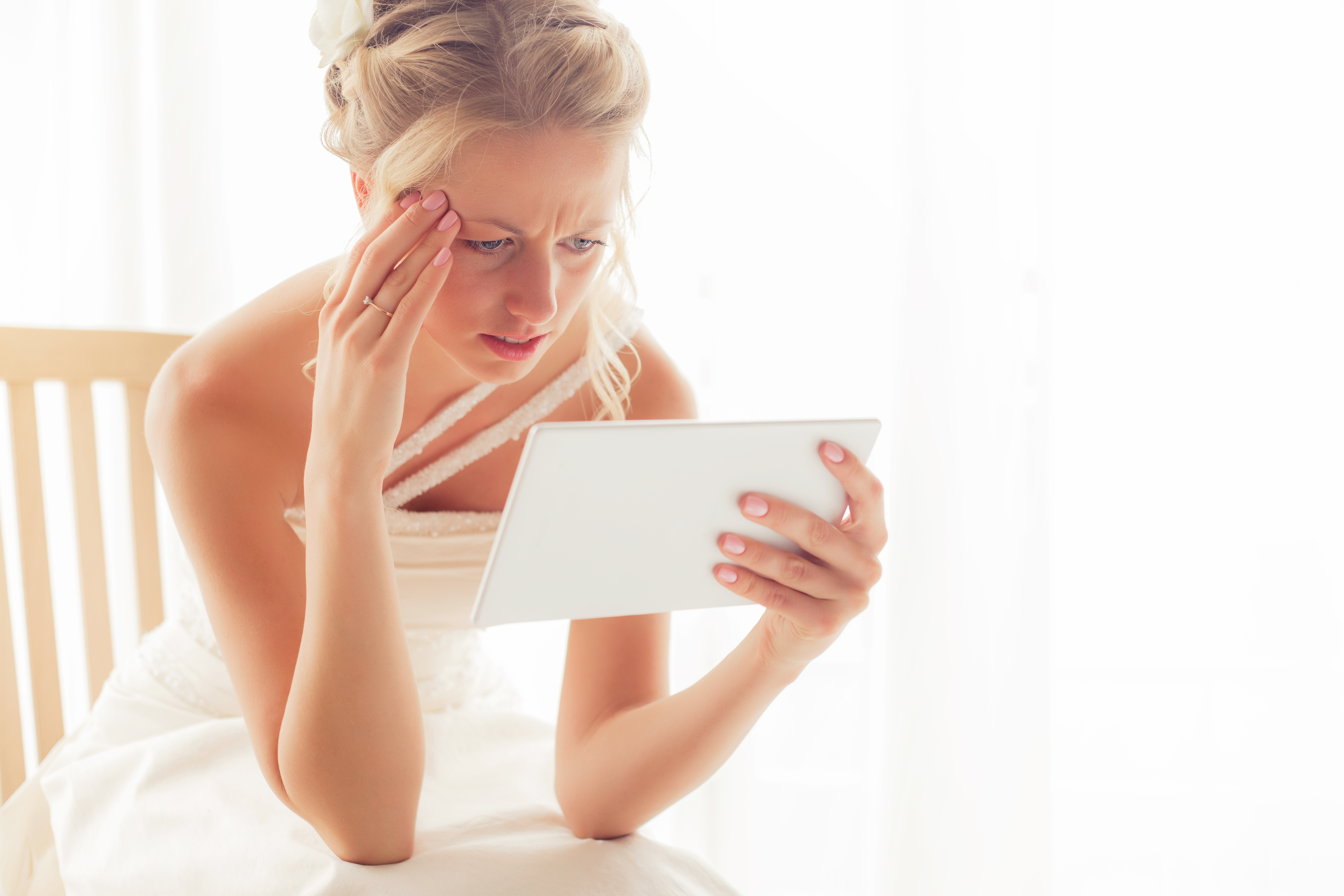 Woman looking at tablet | Source: Shutterstock
