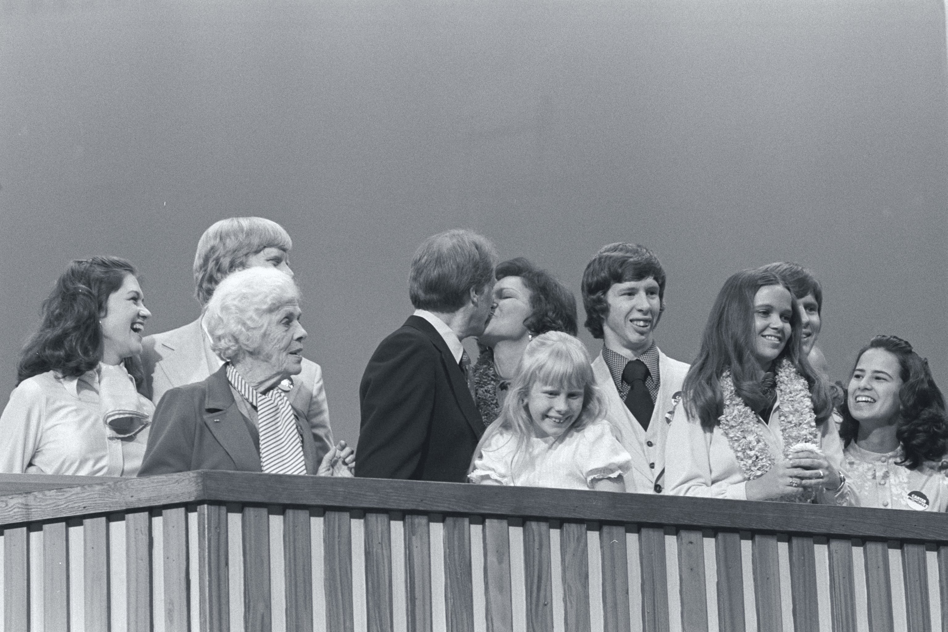 Jimmy Carter kissed his wife, Rosalynn, at the podium with his family by their side at the 1976 Democratic National Convention. | Source: Getty Images