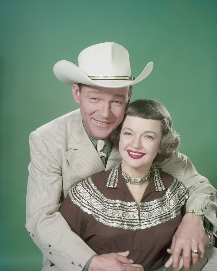 Singer and actor Roy Rogers and his wife Dale Evans pictured smiling with Rogers seated behind his wife with his arms around her USA, circa 1955. | Photo: Getty Images