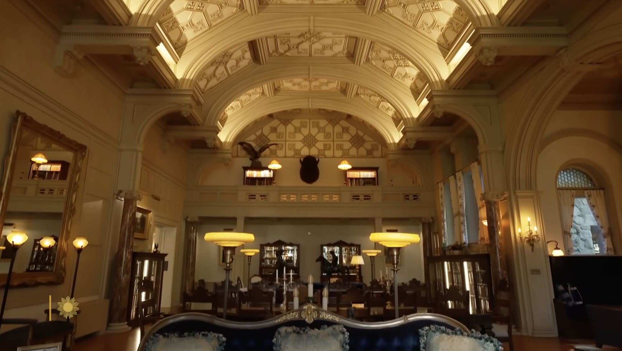 Ornate architecture and vaulted ceilings define the interior of a grand lodge-style property connected to Ted Turner’s conservation empire. | Source: YouTube/CBS Sunday Morning