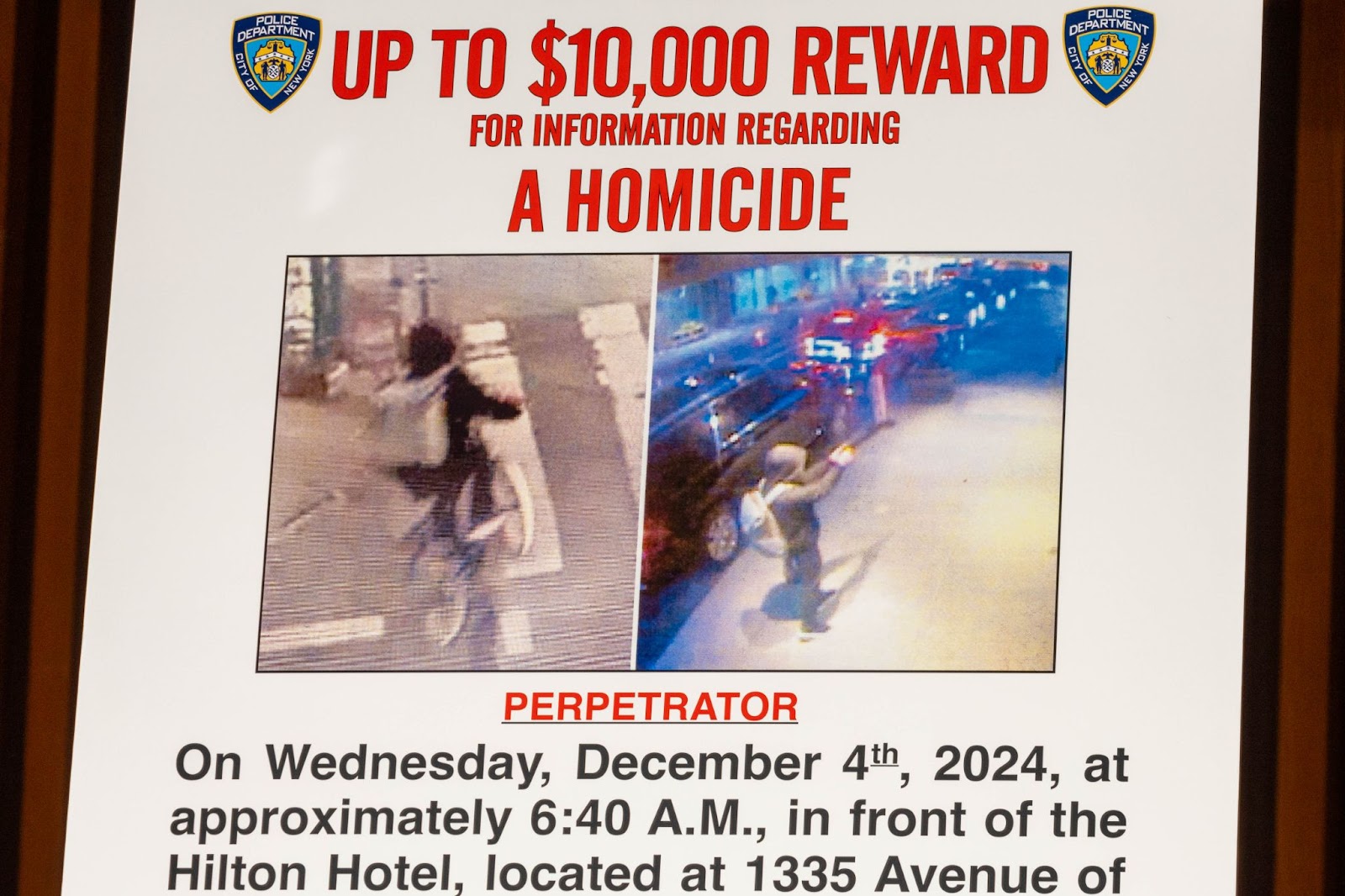 A wanted poster set up for an NYPD press conference regarding UnitedHealthcare CEO Brian Thompson's fatal shooting in New York. | Source: Getty Images