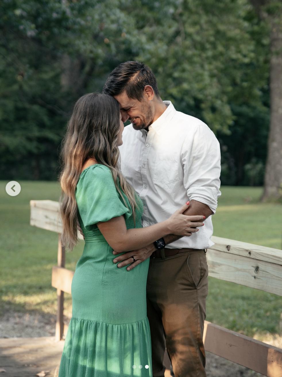 In a sunlit park, Stephen Wissmann and Jana Duggar share a forehead-to-forehead embrace, smiling as they stand wrapped in each other's arms, as posted on August 17, 2025 | Source: Instagram/@janamduggar | Instagram/@stephenwissmann