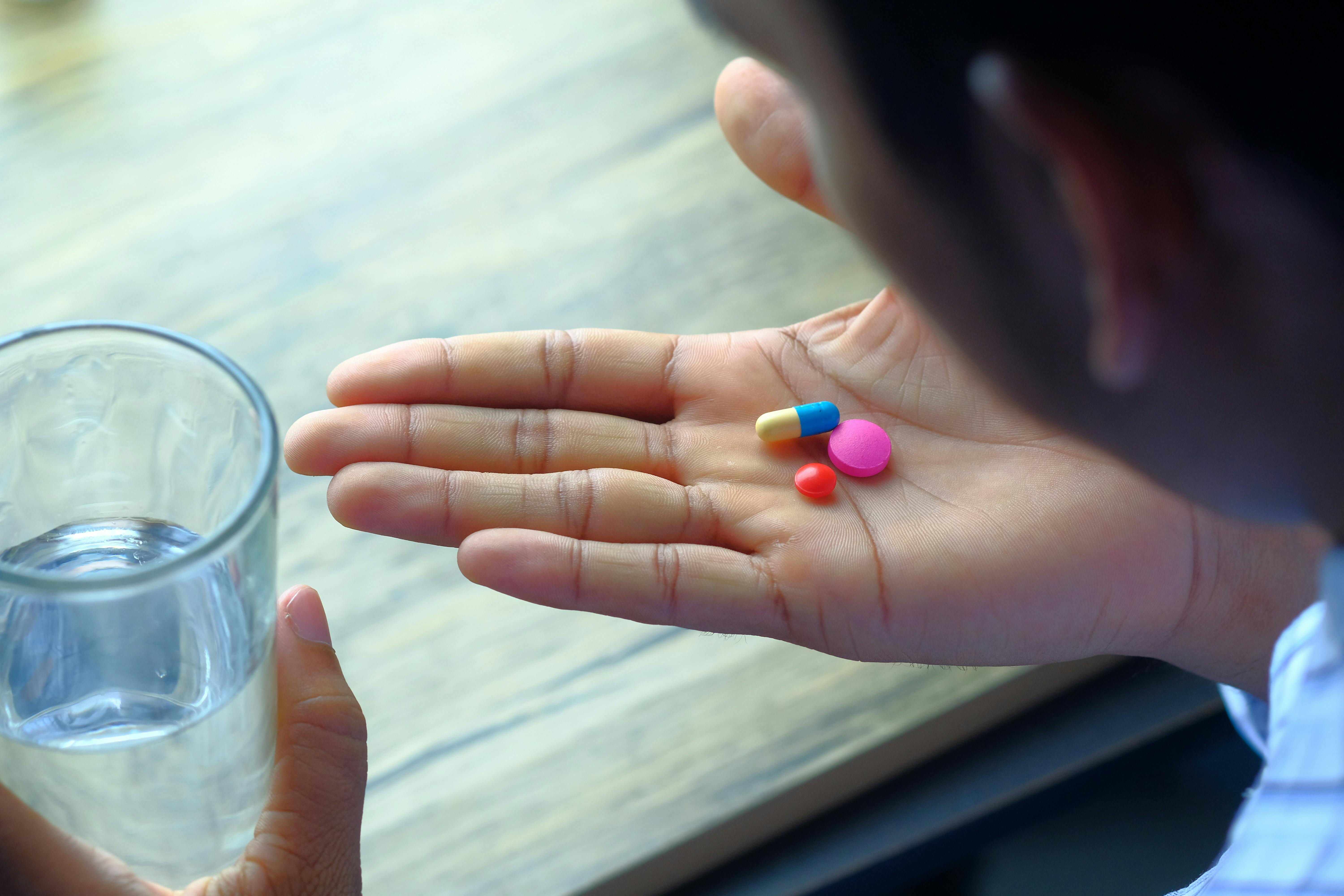 A woman taking vitamins | Source: Pexels