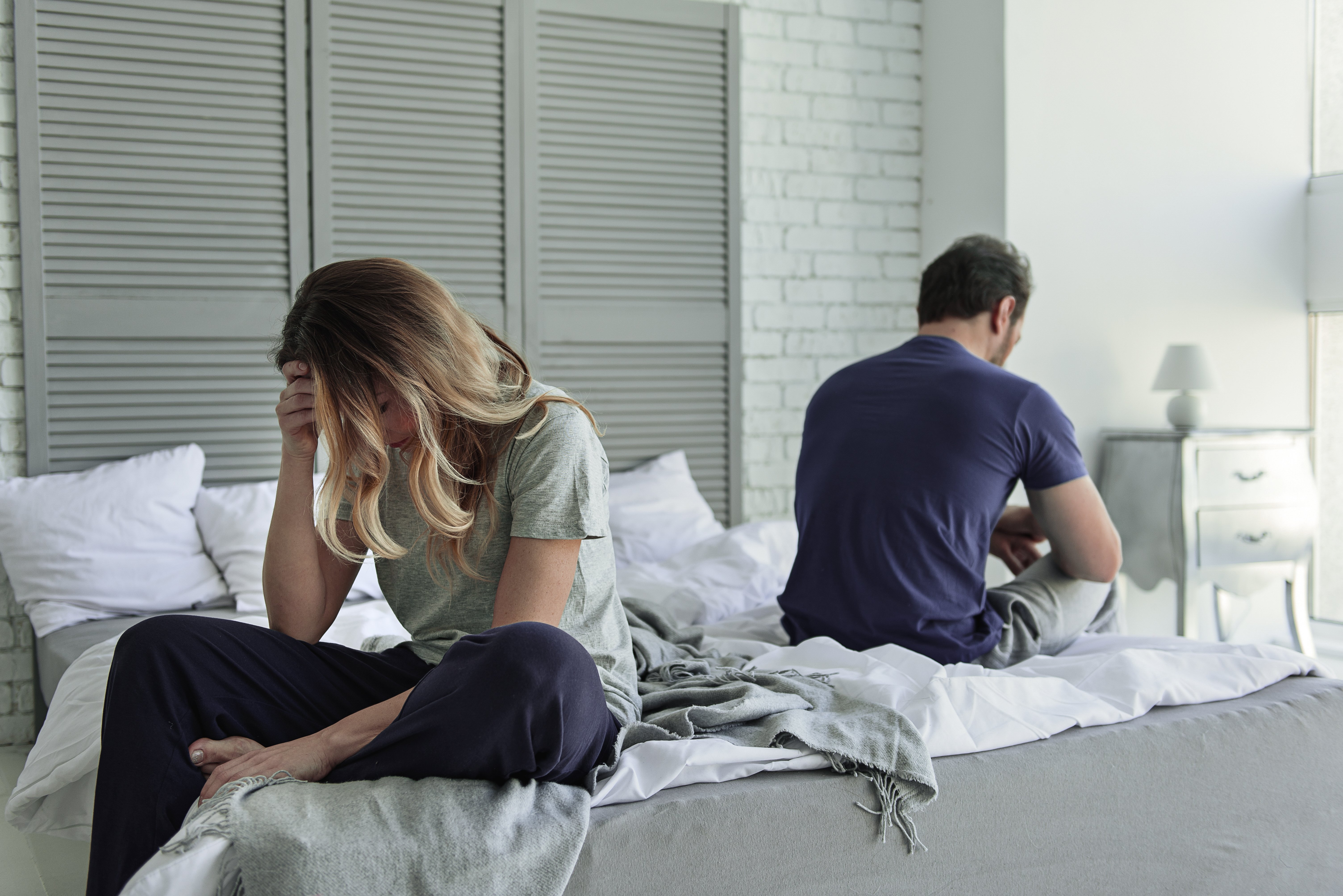 Despaired married couple on the bed | Photo: Shutterstock