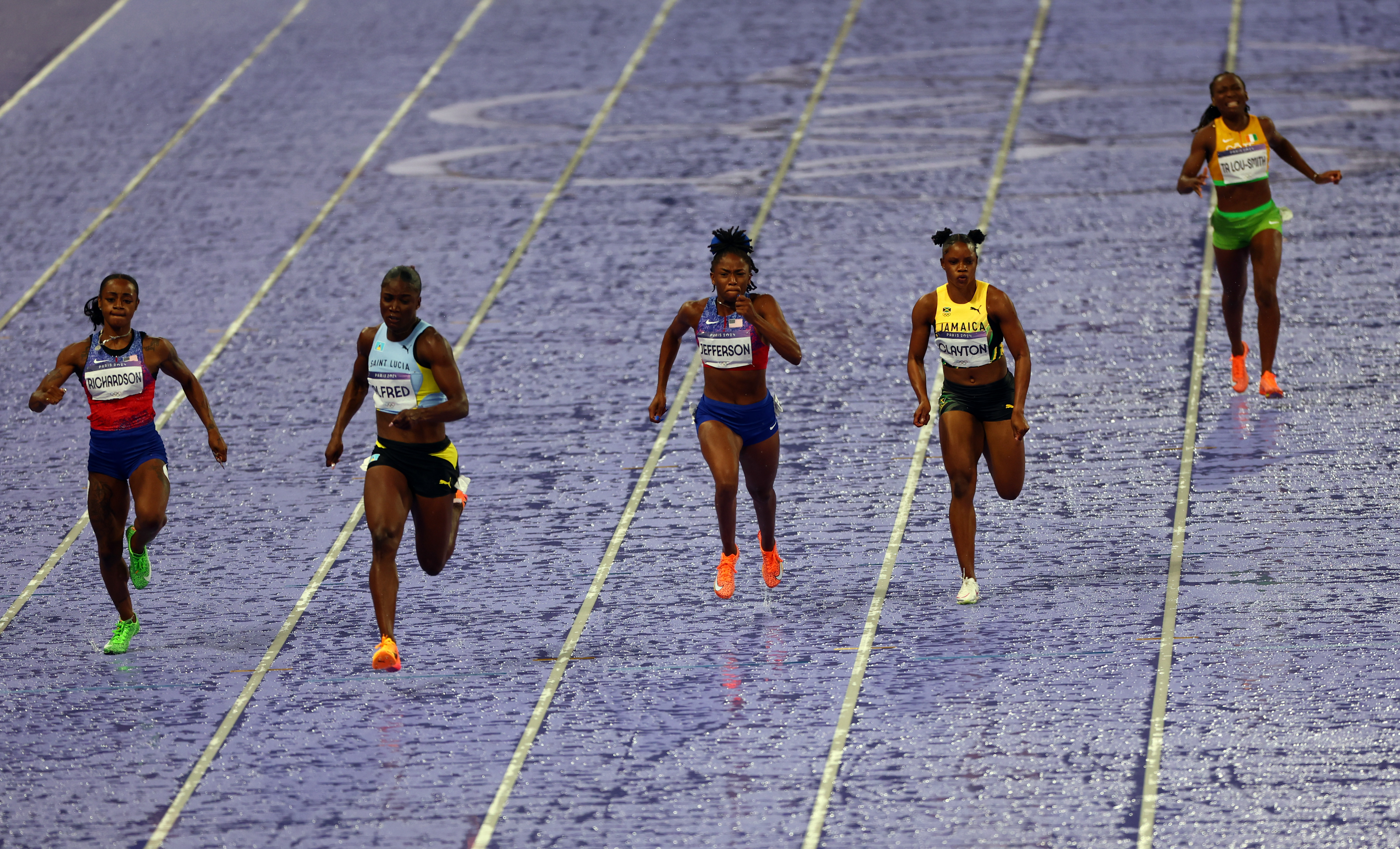 Sha'Carri Richardson racing alongside fellow female athletes in the women's 100m semifinals during the Paris Olympics in Paris, France on August 3, 2024 | Source: Getty Images