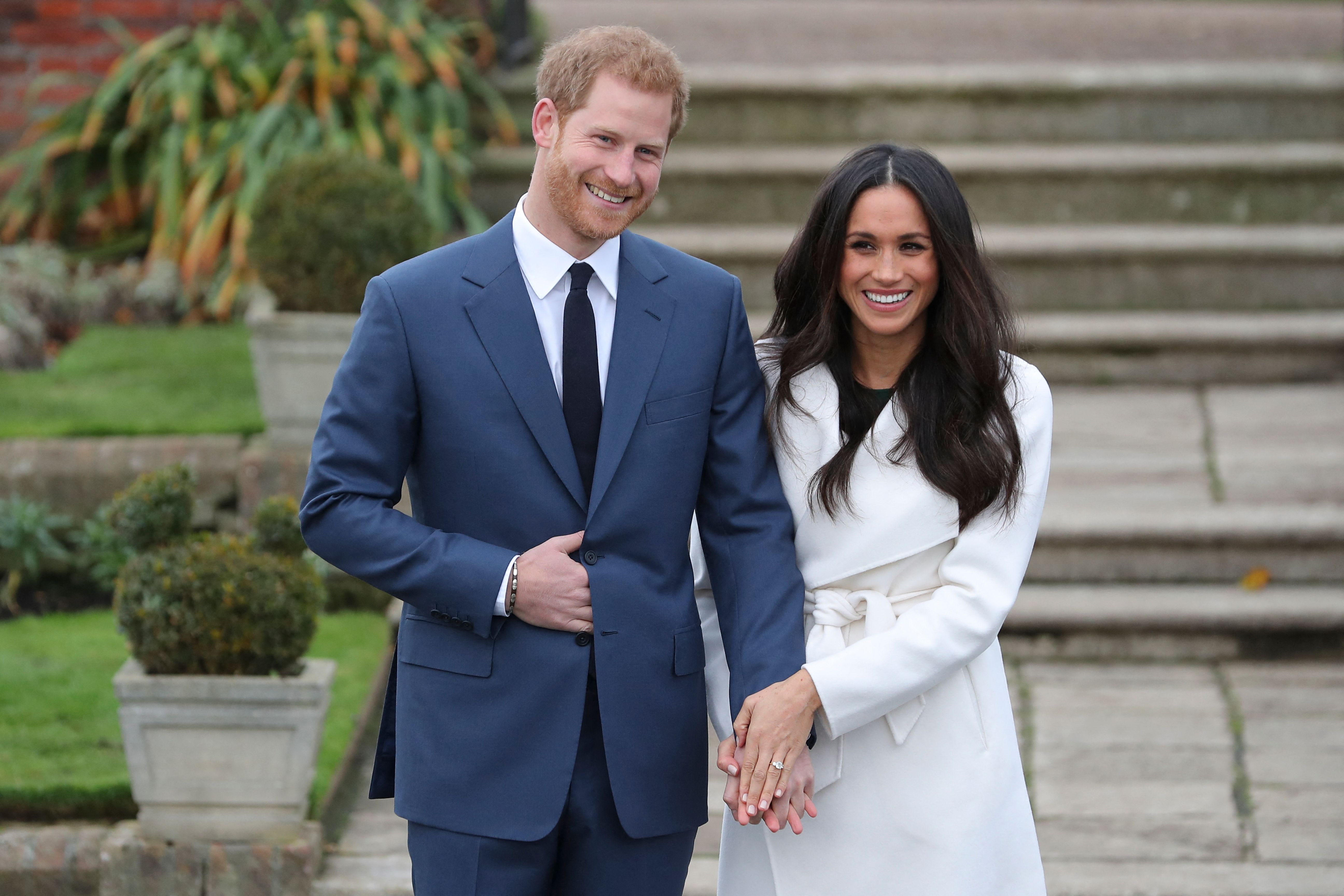 Prince Harry and his fiancée actress Meghan Markle posing for a photograph in the Sunken Garden at Kensington Palace in west London on November 27, 2017. / Source: Getty Images