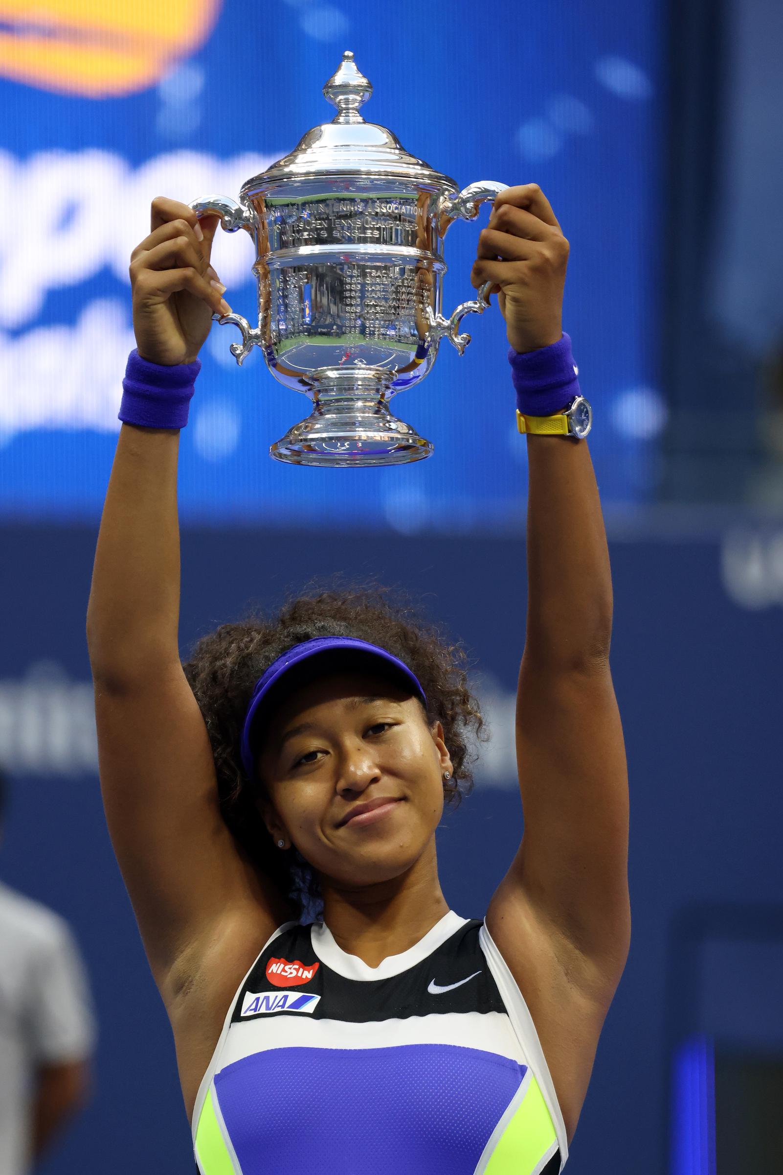 Naomi Osaka hoists her trophy over her head after winning her Women's Singles final match against Victoria Azarenka of Belarus on Day 13 of the US Open in the Queens borough of New York City on September 12, 2020. | Source: Getty Images