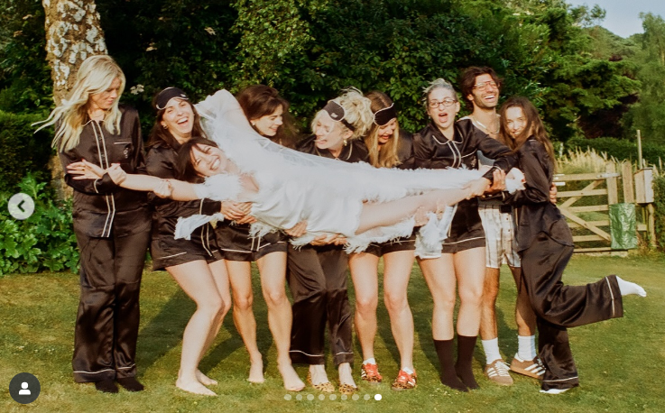 Lifted by friends during a countryside celebration, Daisy Lowe shares a joyful moment in a feathered robe during her pre-wedding festivities, posted on June 4, 2025 | Source: Instagram/agentprovocateur