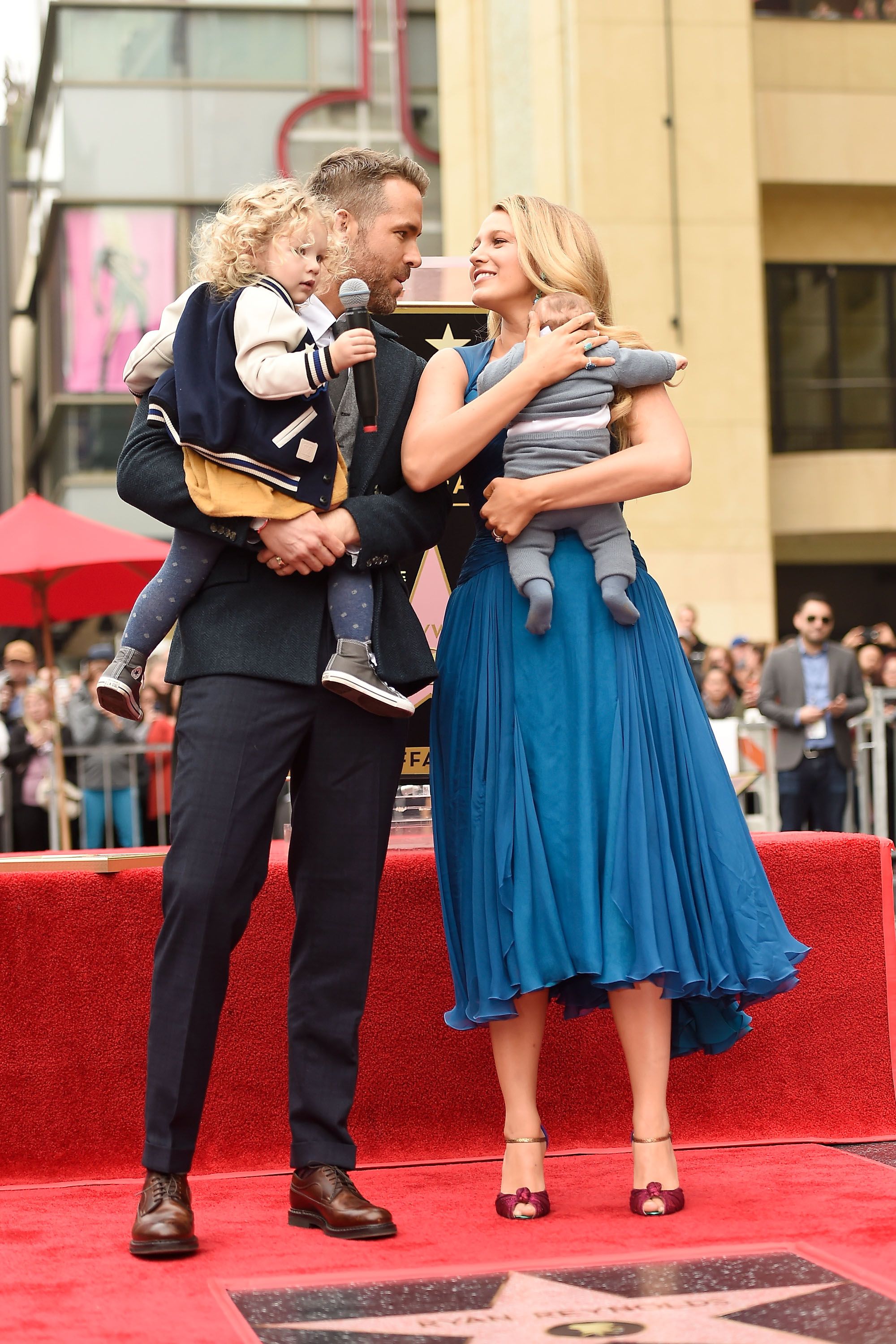 Ryan Reynolds (L) and Blake Lively pose with their daughters as Ryan Reynolds is honored with star on the Hollywood Walk of Fame. | Source: Getty Images
