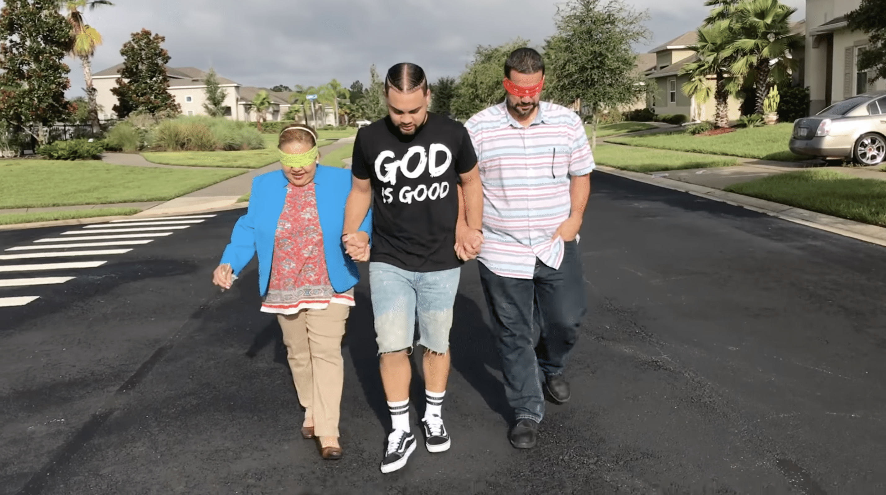 LeJuan James taking his parents for the house reveal with blindfolds on their eyes. | Photo: YouTube.com/LeJuan James