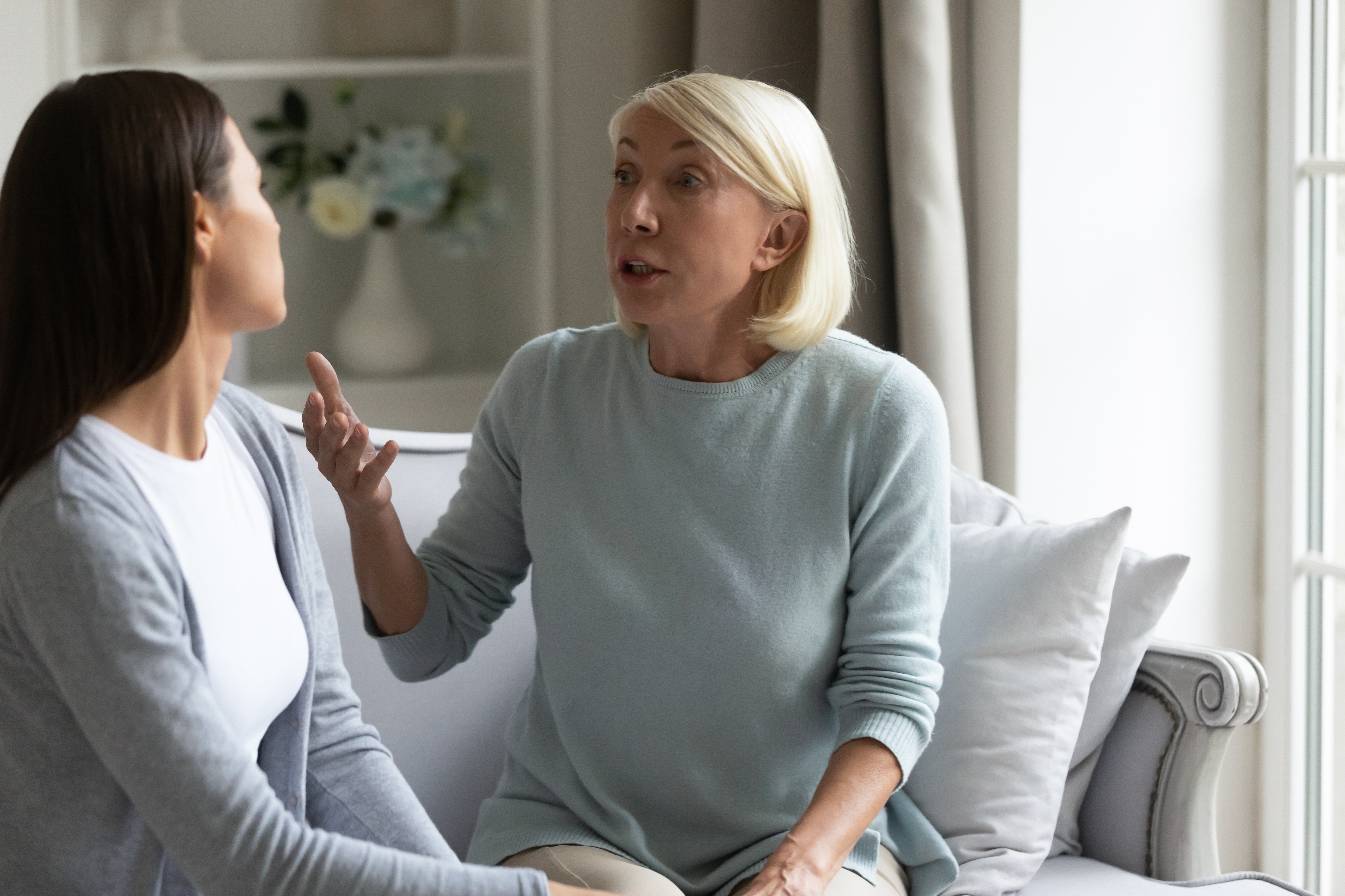 An angry 50s mother having a dispute with grown-up daughter | Source: Shutterstock