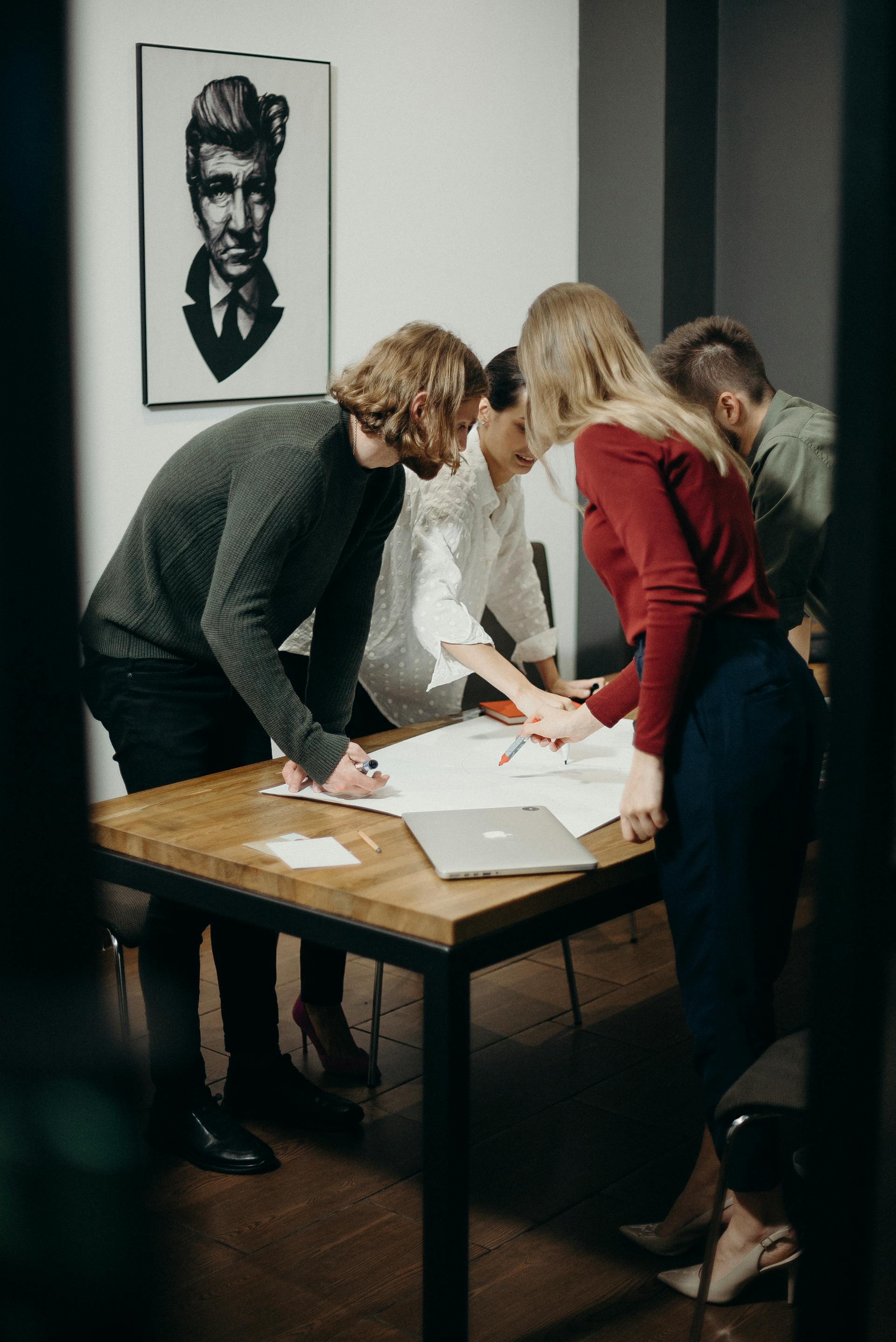 A group of people standing around a table | Source: Pexels