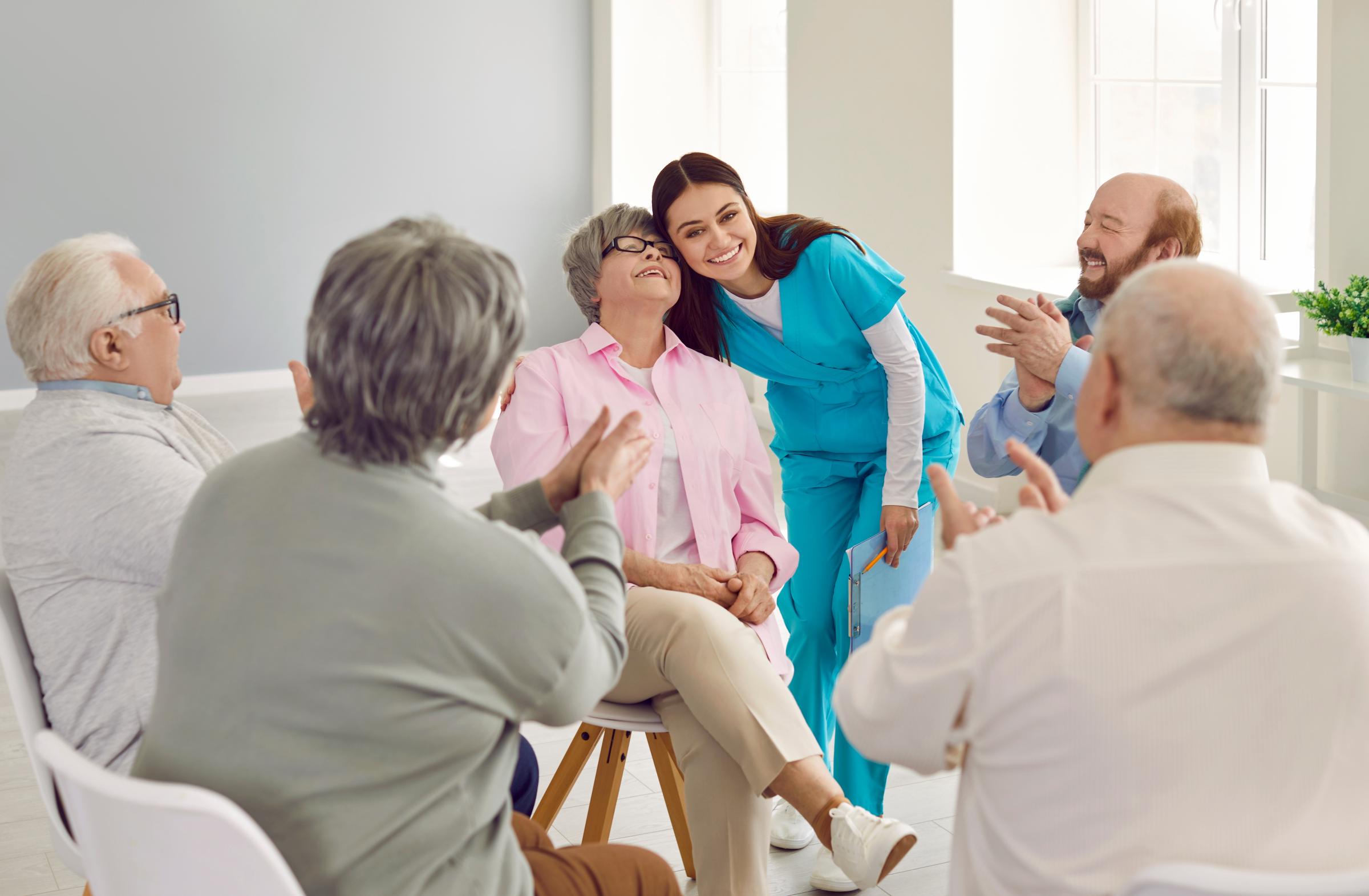 Friendly nurse attending to patients at a nursing home | Source: Shutterstock