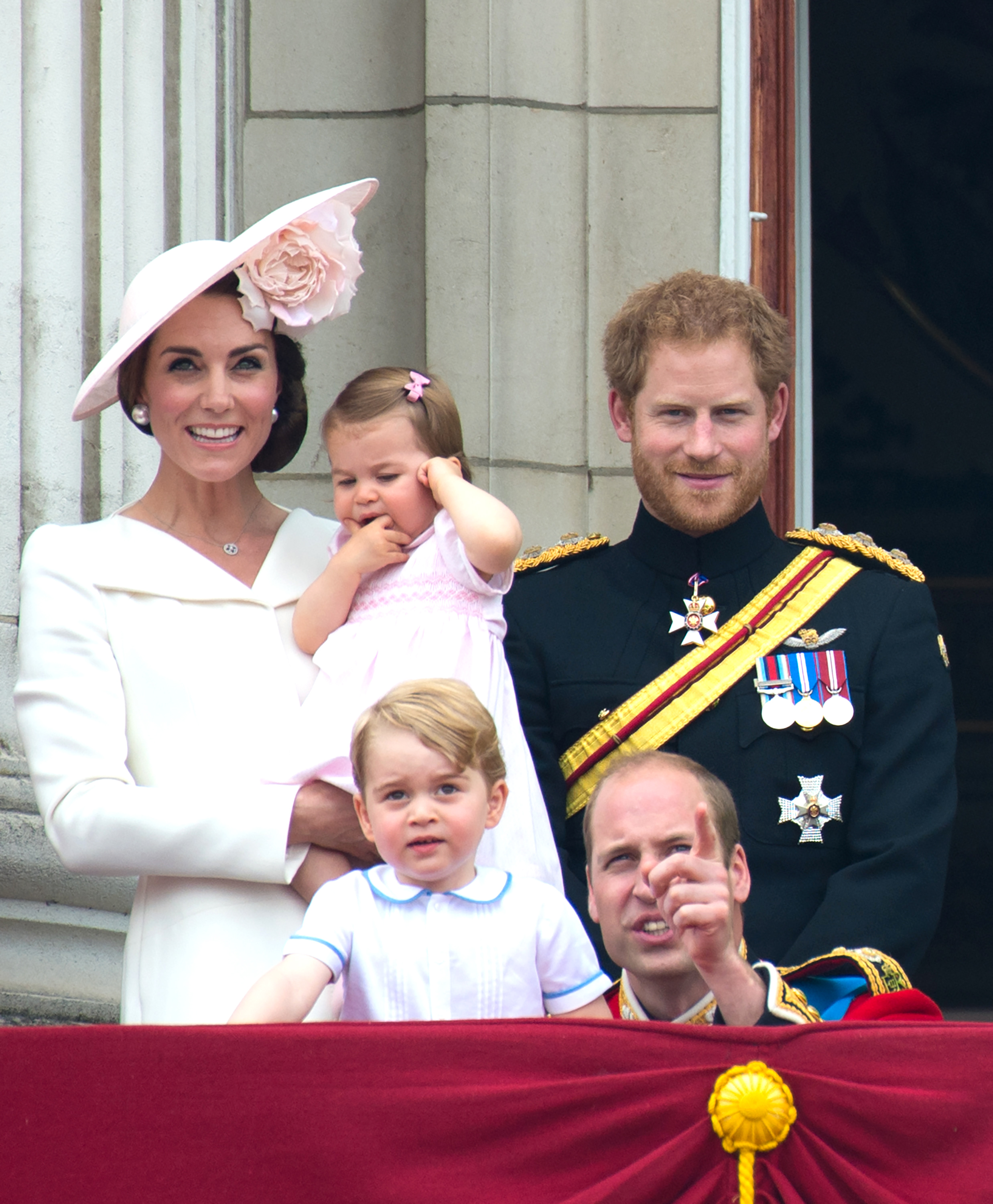 Princess Catherine holding her daughter Princess Charlotte, Prince George, Prince William, and Prince Harry on the balcony of Buckingham Palace during the Trooping the Colour on June 11, 2016, in London, England. | Source: Getty Images