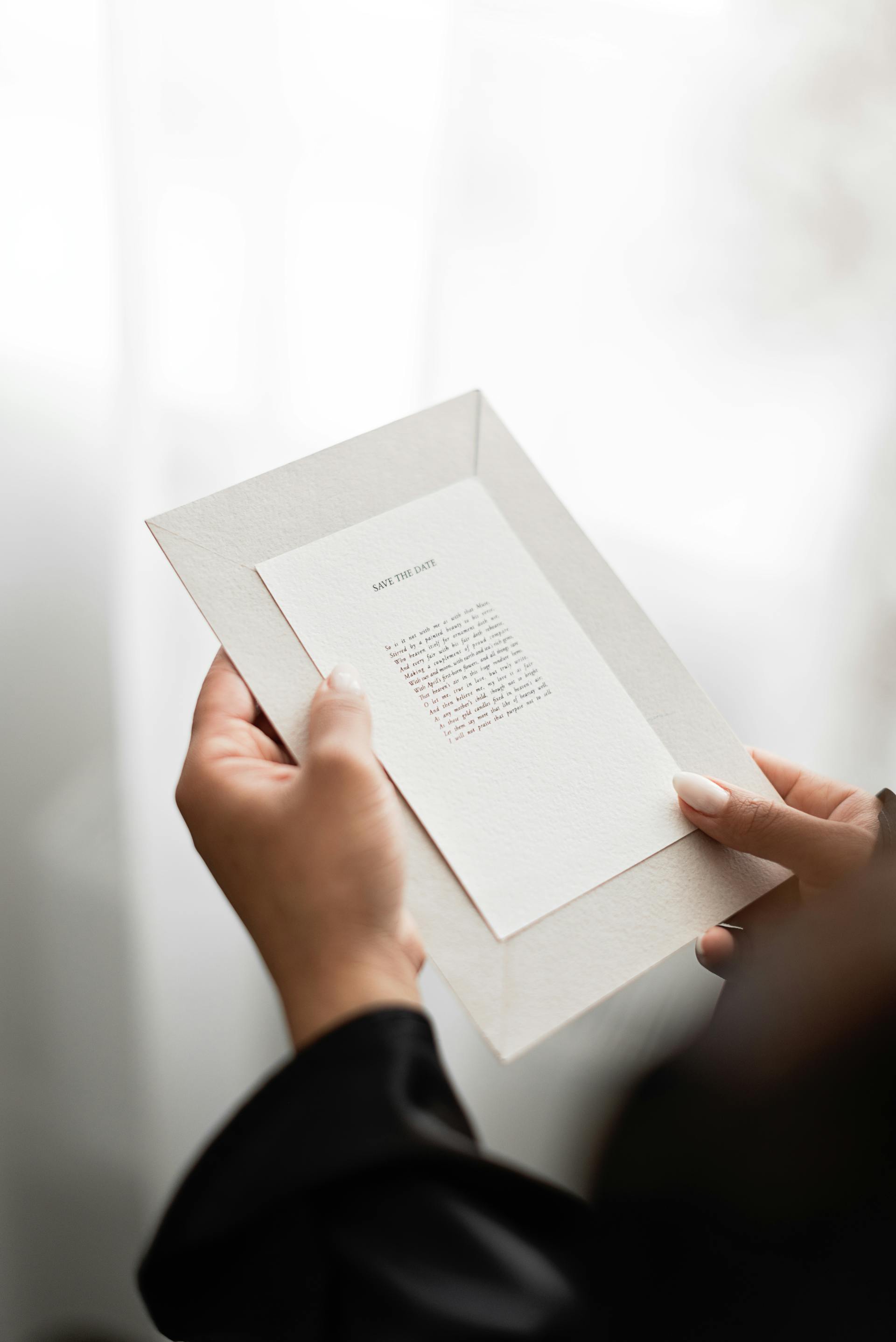 A closeup of a person holding an invitation card | Source: Pexels