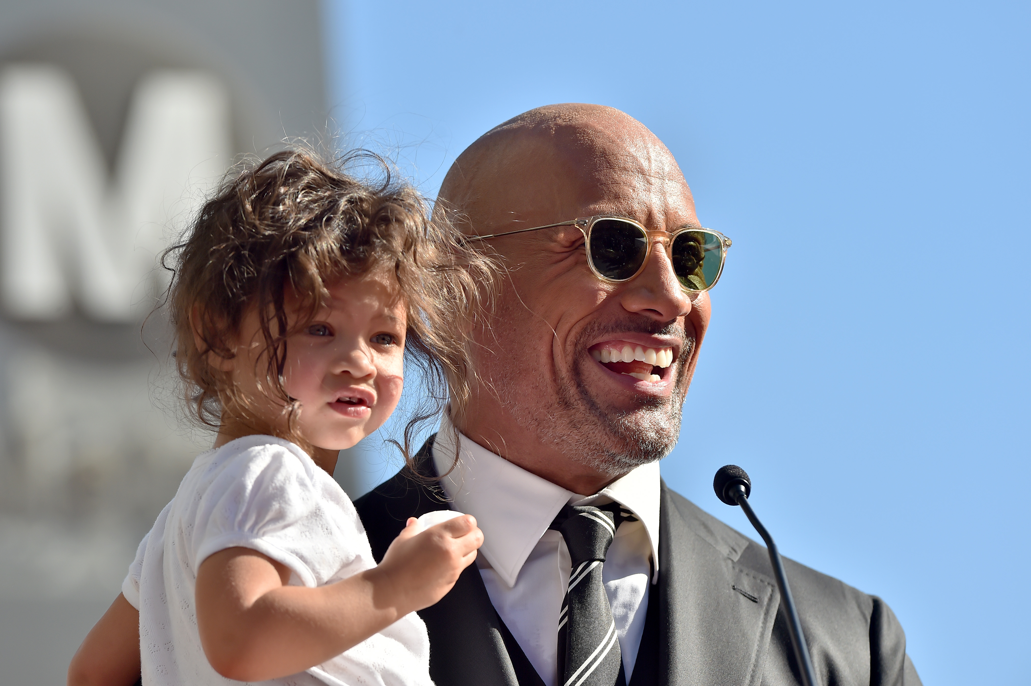 Dwayne and Jasmine Johnson attend a ceremony honoring him with a star on The Hollywood Walk of Fame on December 13, 2017 | Source: Getty Images